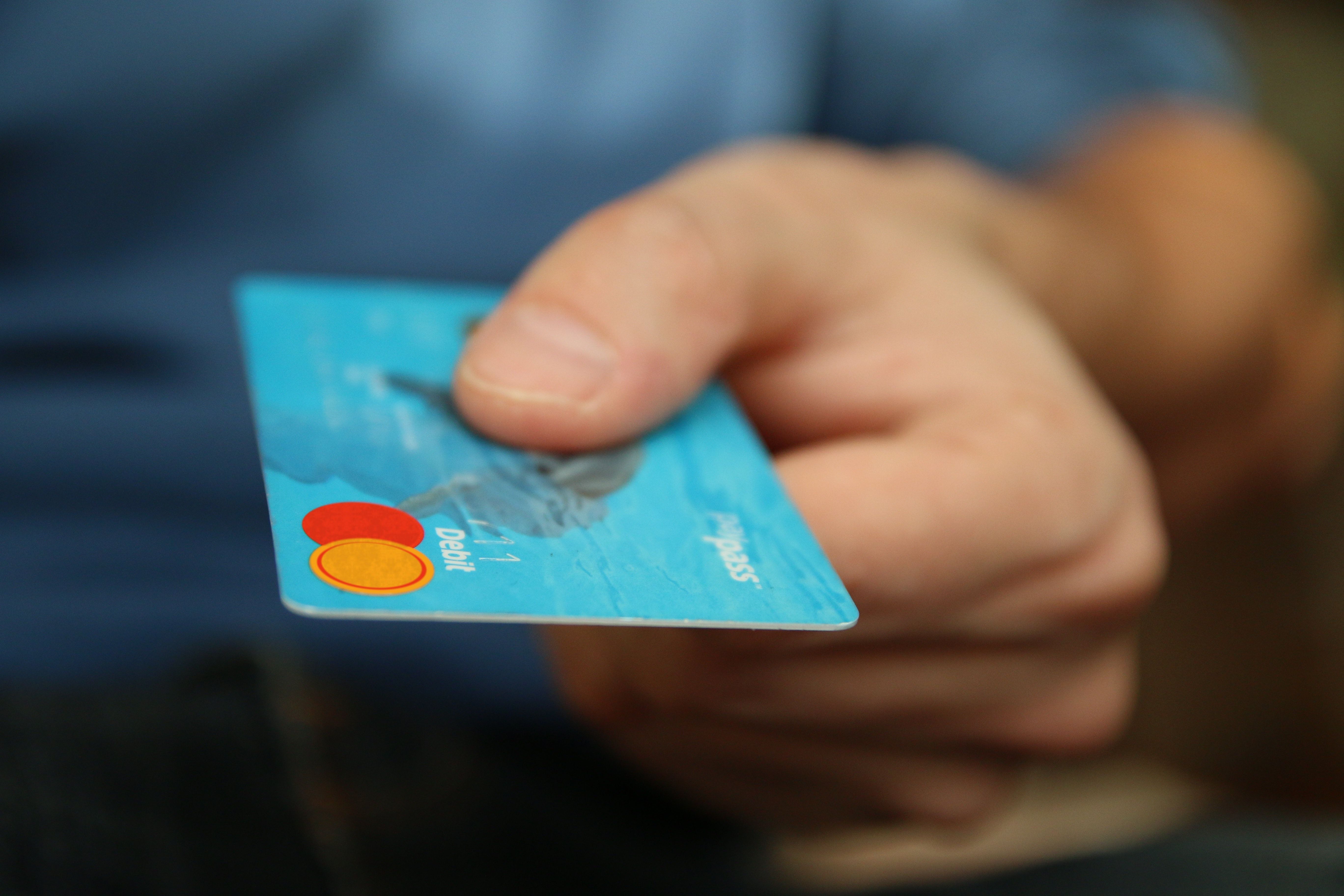 Person Holding Debit Card · Free