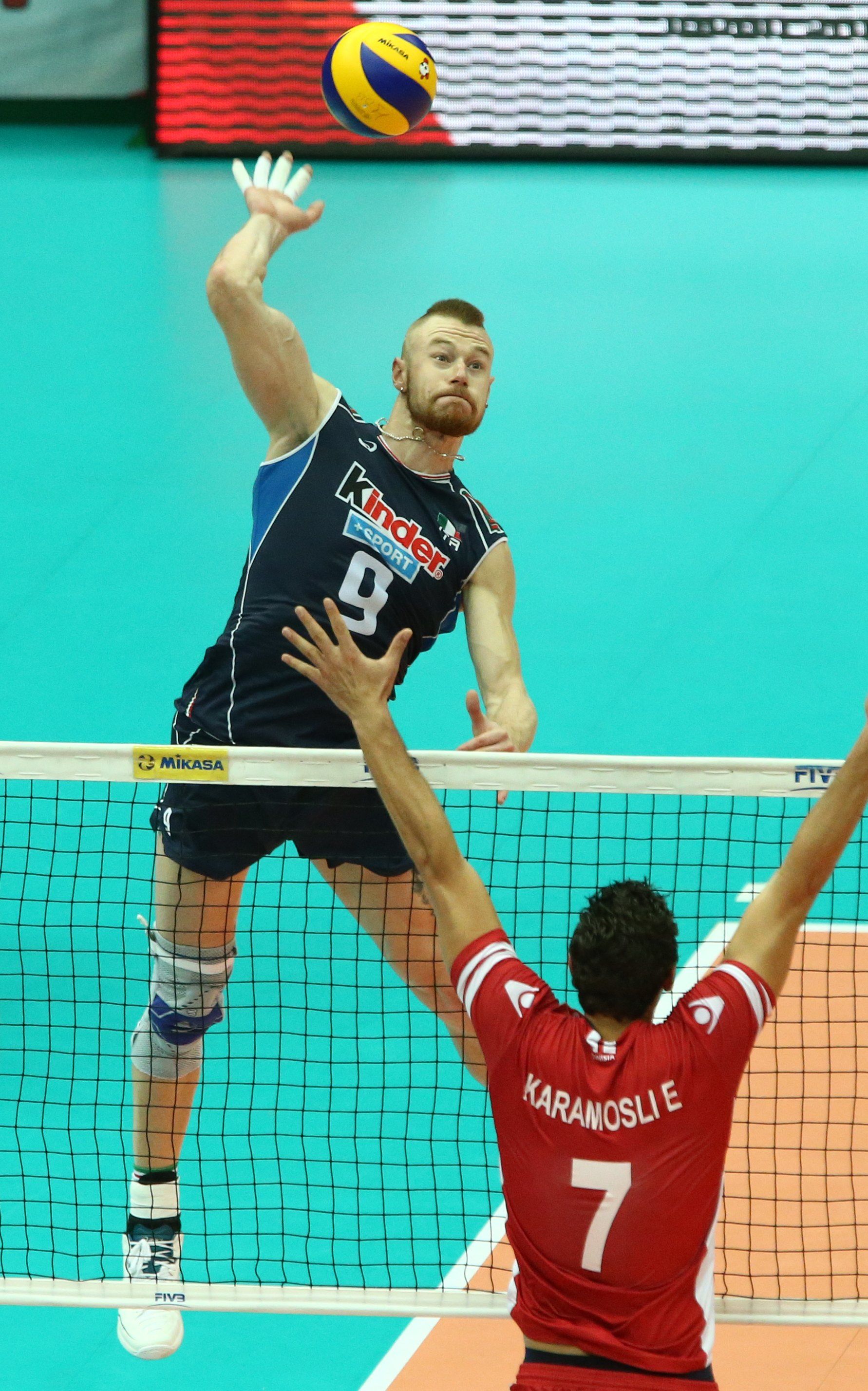 Ivan Zaytsev spikes against Tunisia's block. Volleyball wallpaper