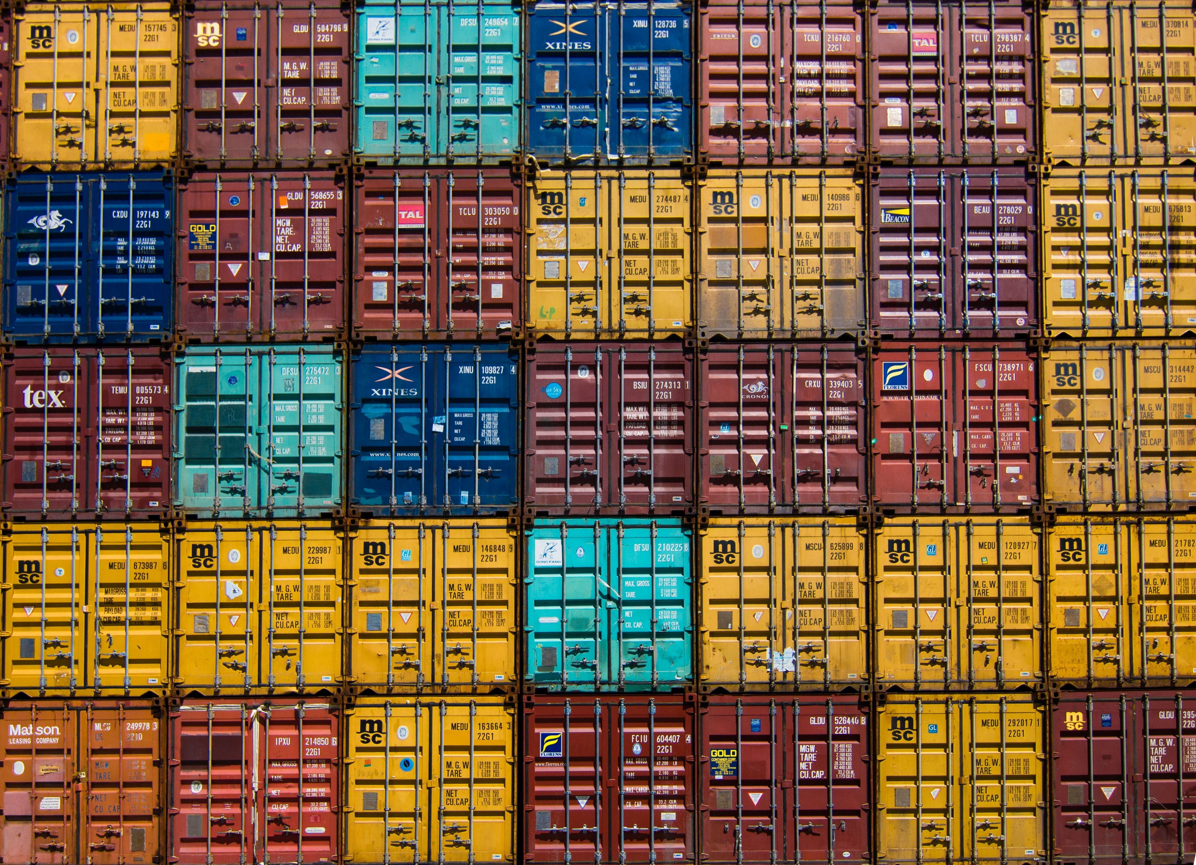 a stack of shipping containers forming a colorful patternshipping