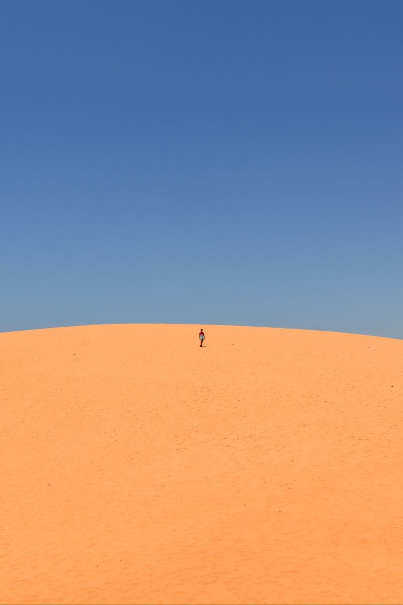 Download wallpaper 800x1200 desert, sand, man, hill, sky, clean