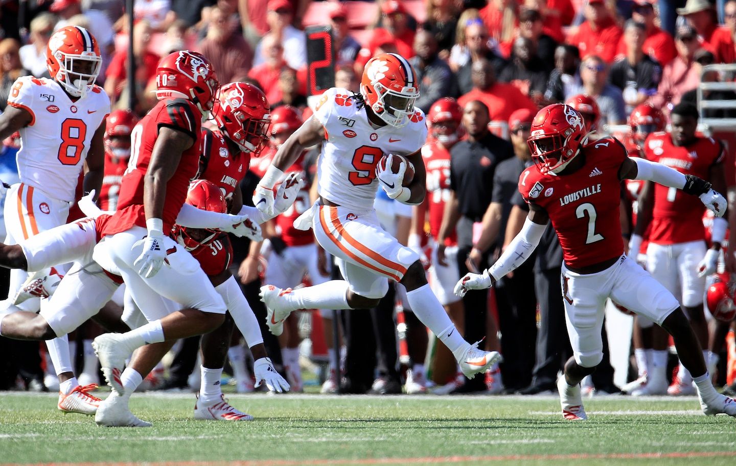 Travis Etienne runs wild for Clemson, then limps off the field