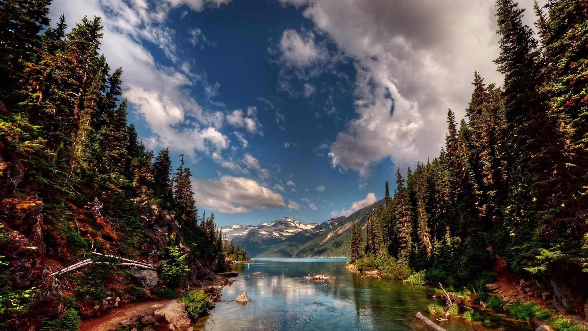 Nature landscape with river, trees, mountains, clouds
