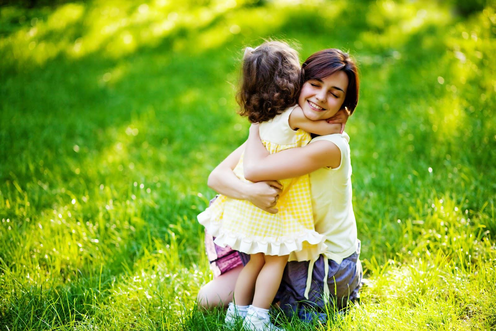 Loving hug of mother and daughter in wheat field, download.