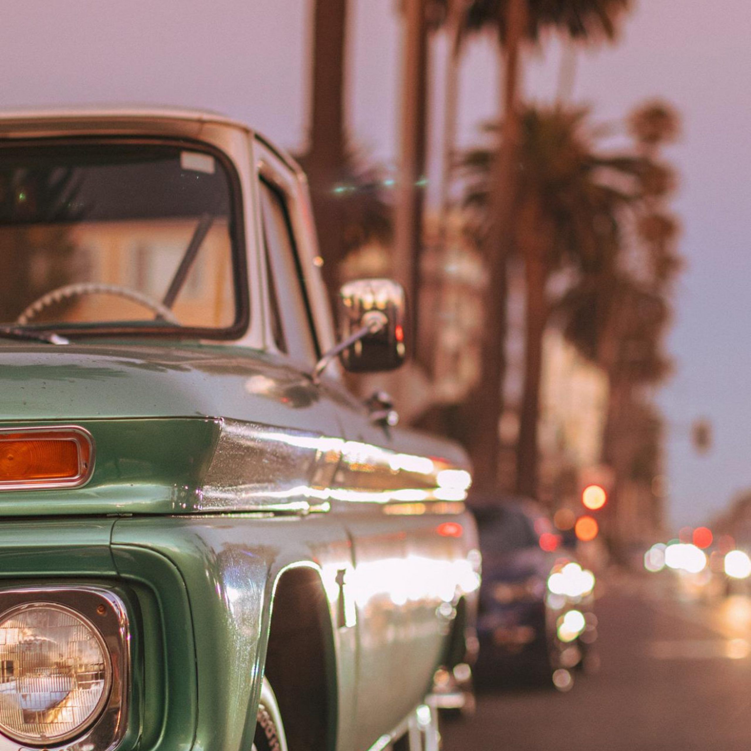 Vintage car parked on Ocean Blvd during sunset iPhone X Wallpaper