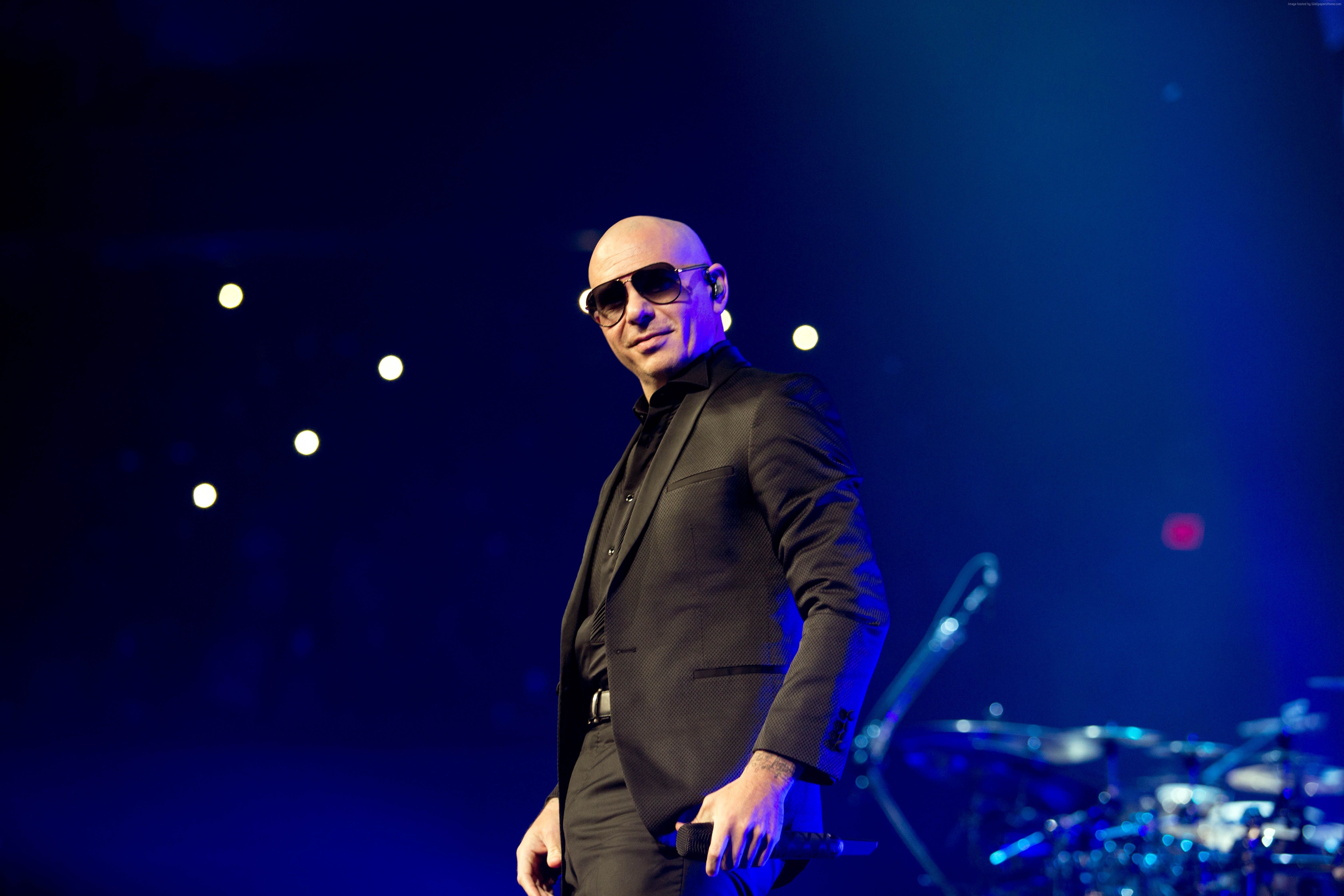 Popular Pitbull singer on stage wearing black glasses Desktop