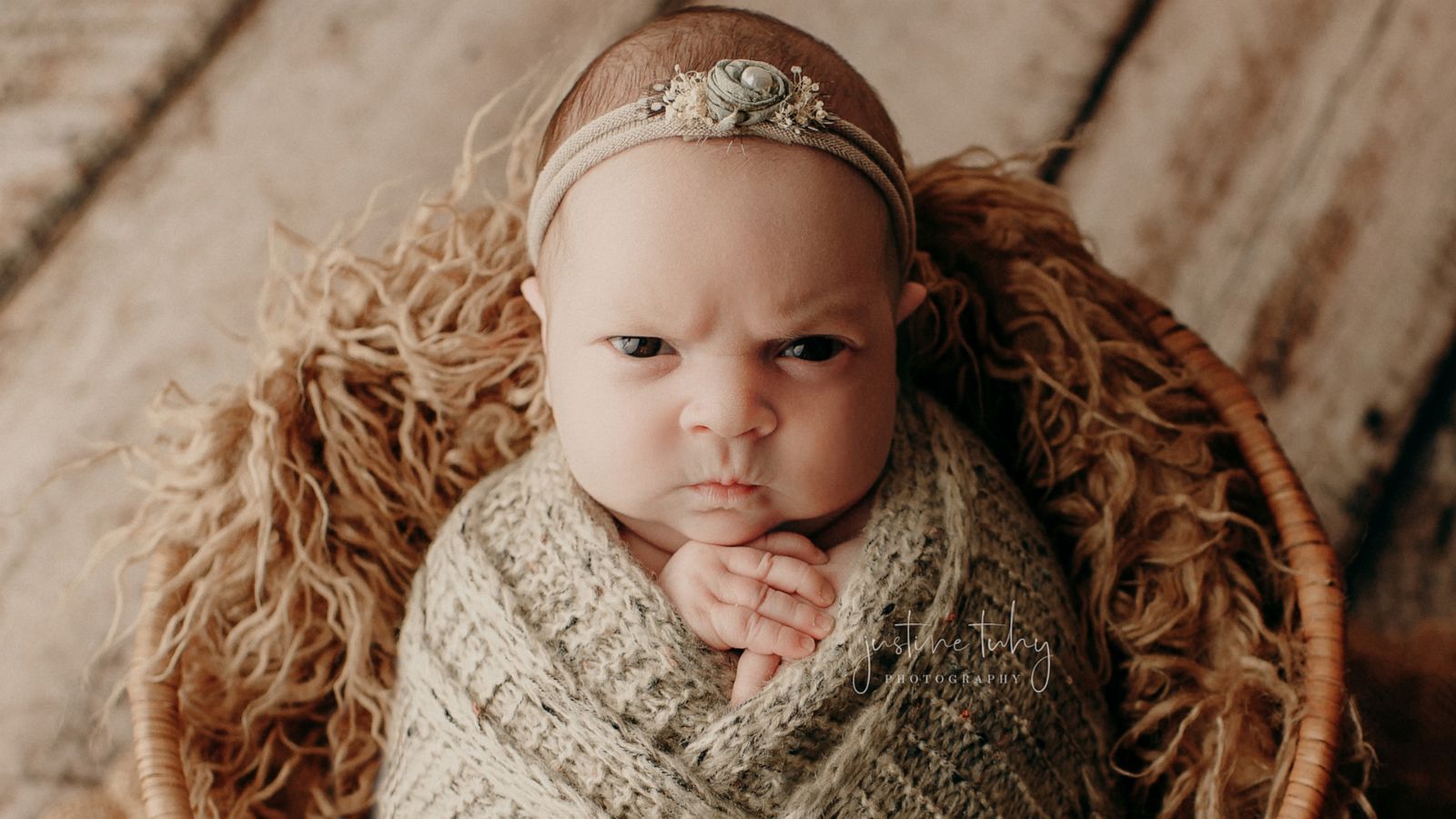 This baby is not feeling it during her newborn photo session