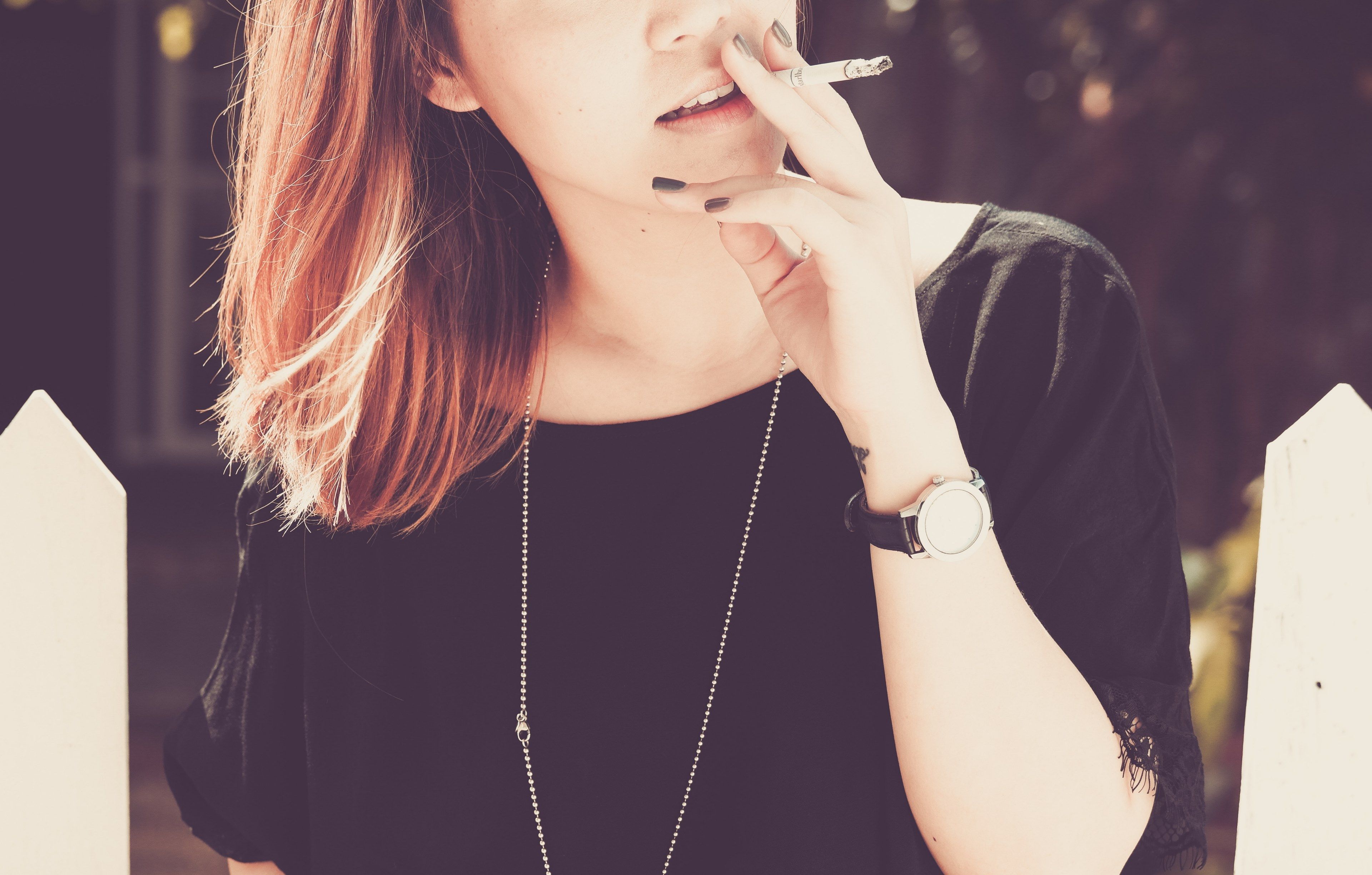 young woman smoking a cigarette outsidebad habits 4k wallpaper