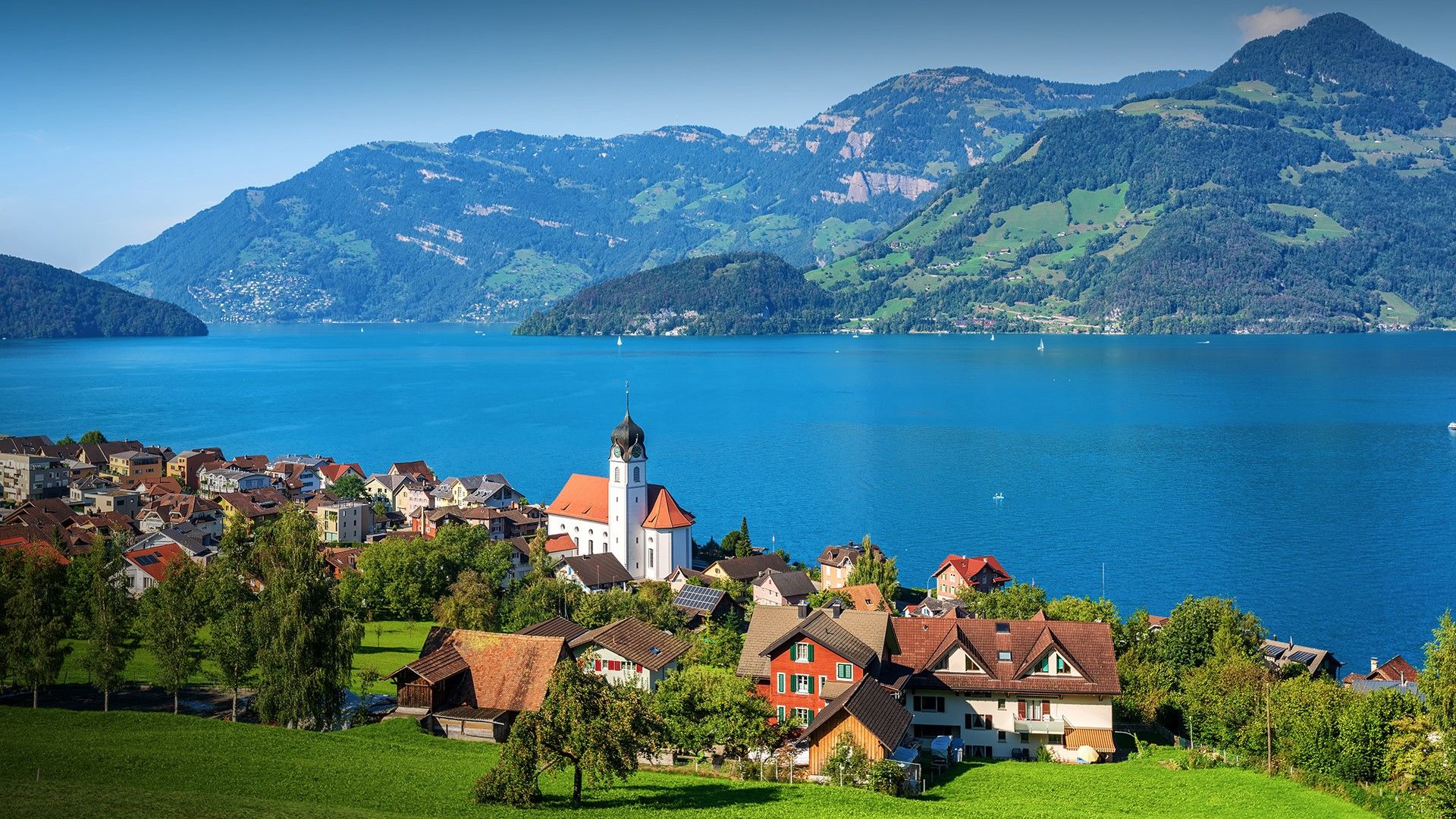 Traditional village Beckenried on Lake Lucerne in Swiss Alps, Switzerland. Windows 10 Spotlight Image