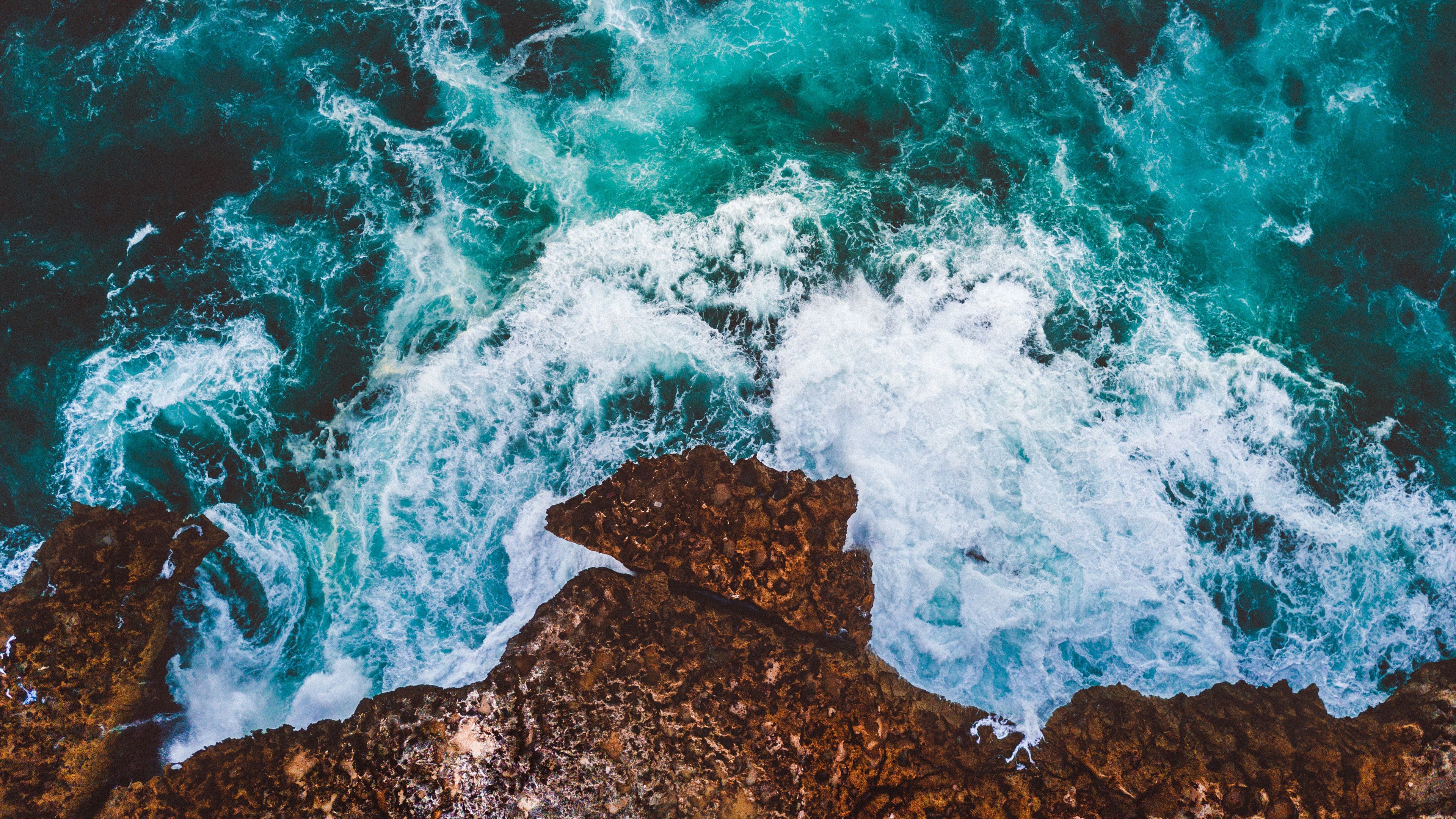 Waves crashing against the rocks 4k Ultra HD Wallpaper