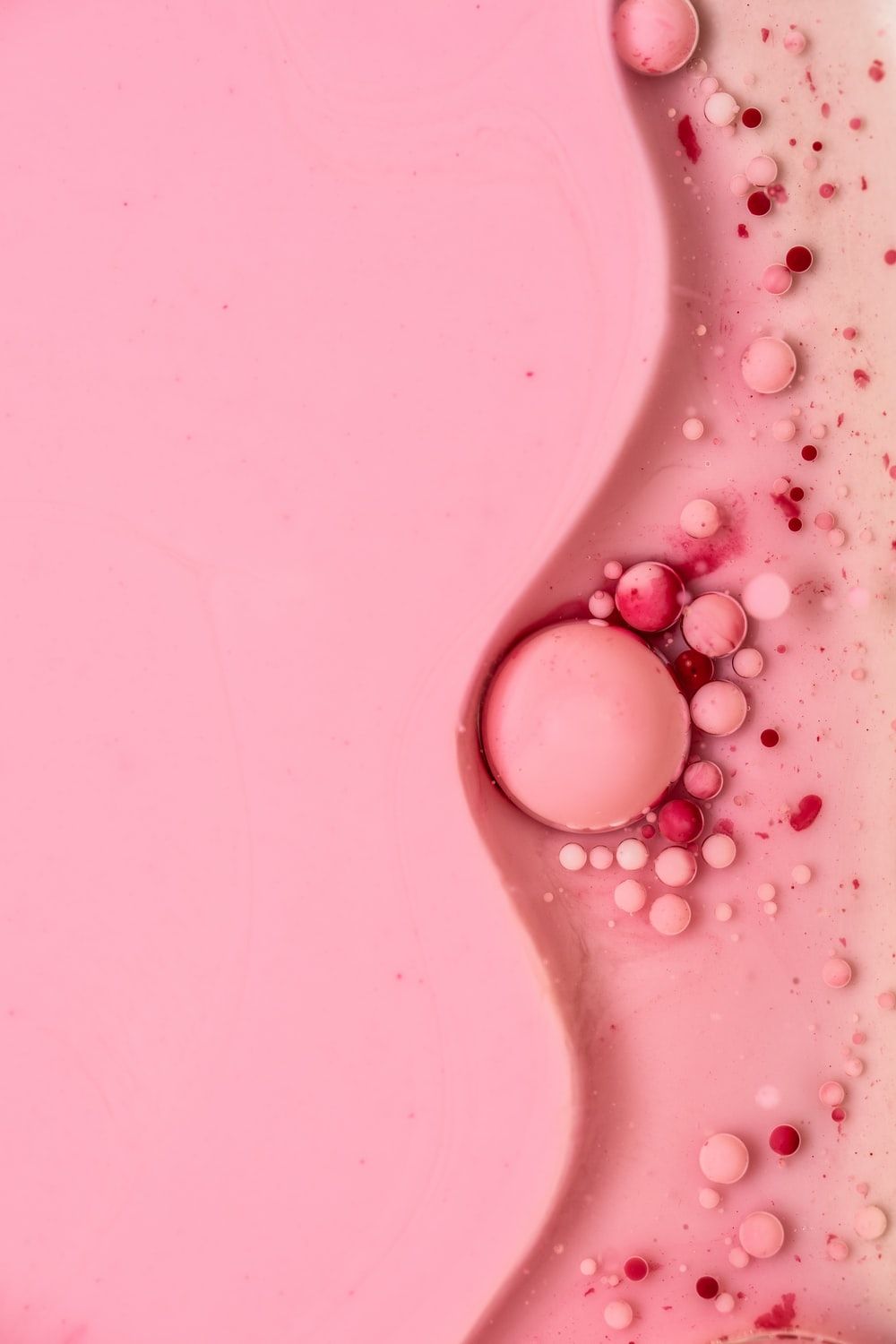white round beads on pink surface photo