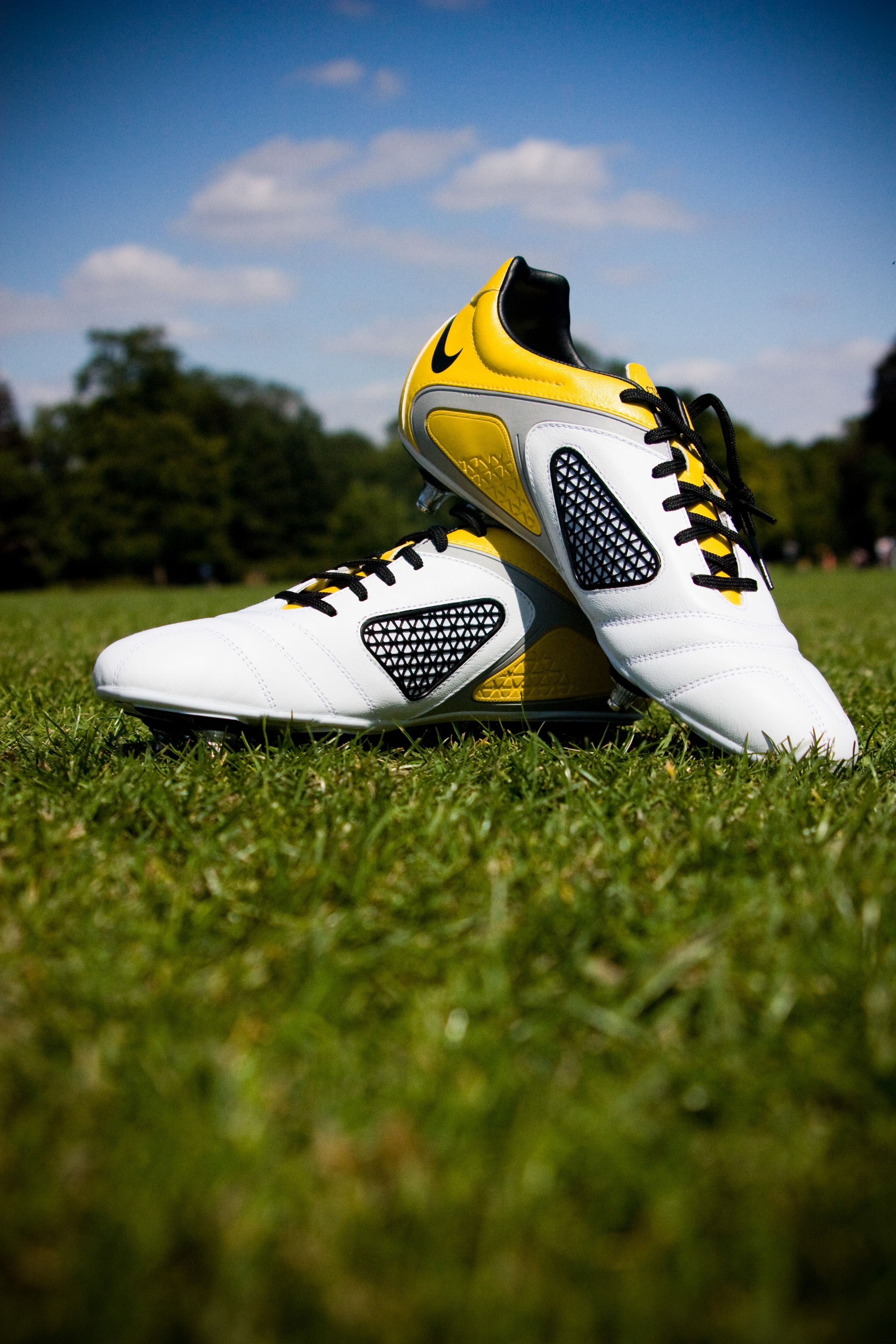 Pair Of White And Yellow Nike Cleats · Free