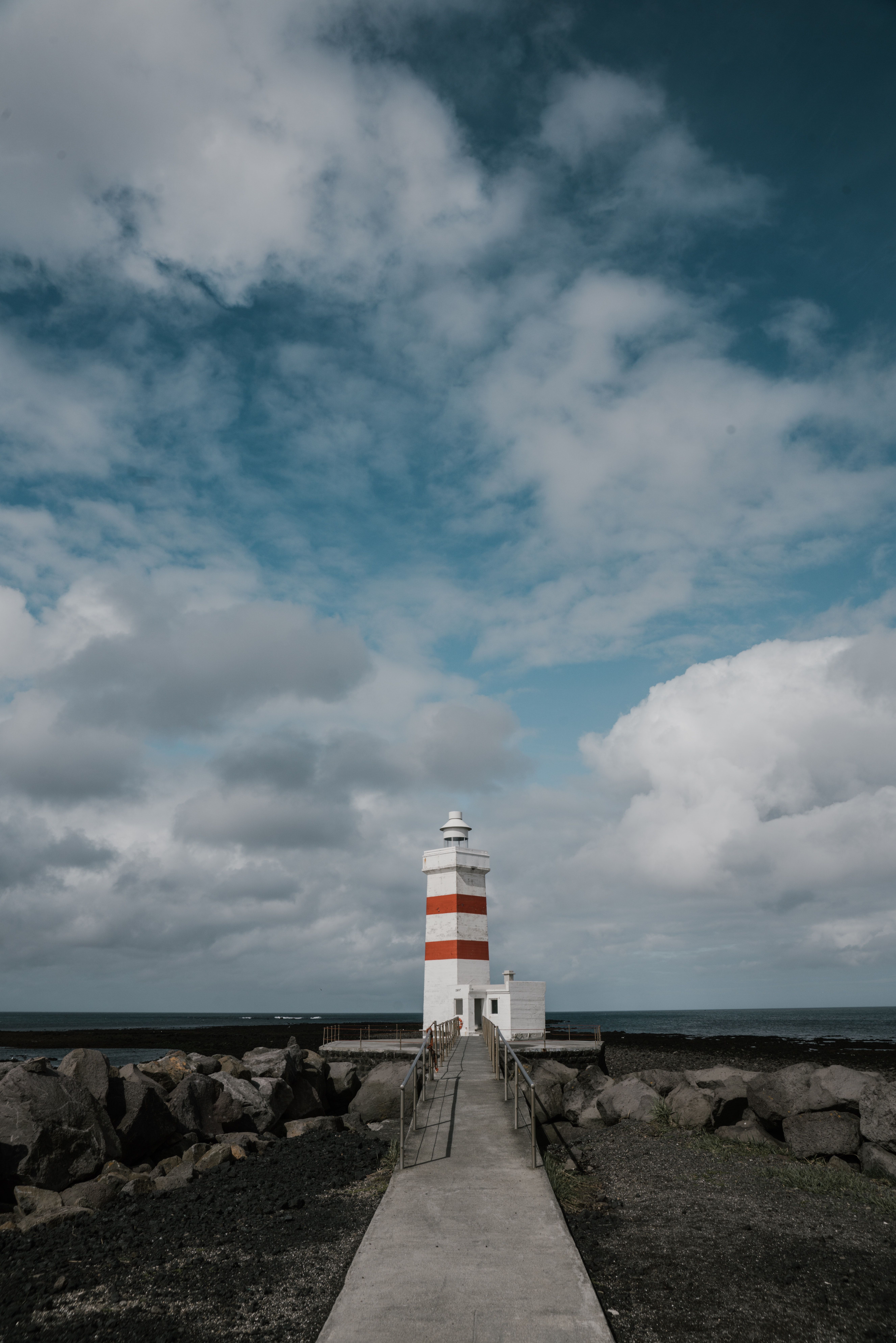 Old lighthouse against cloudy blue sky · Free