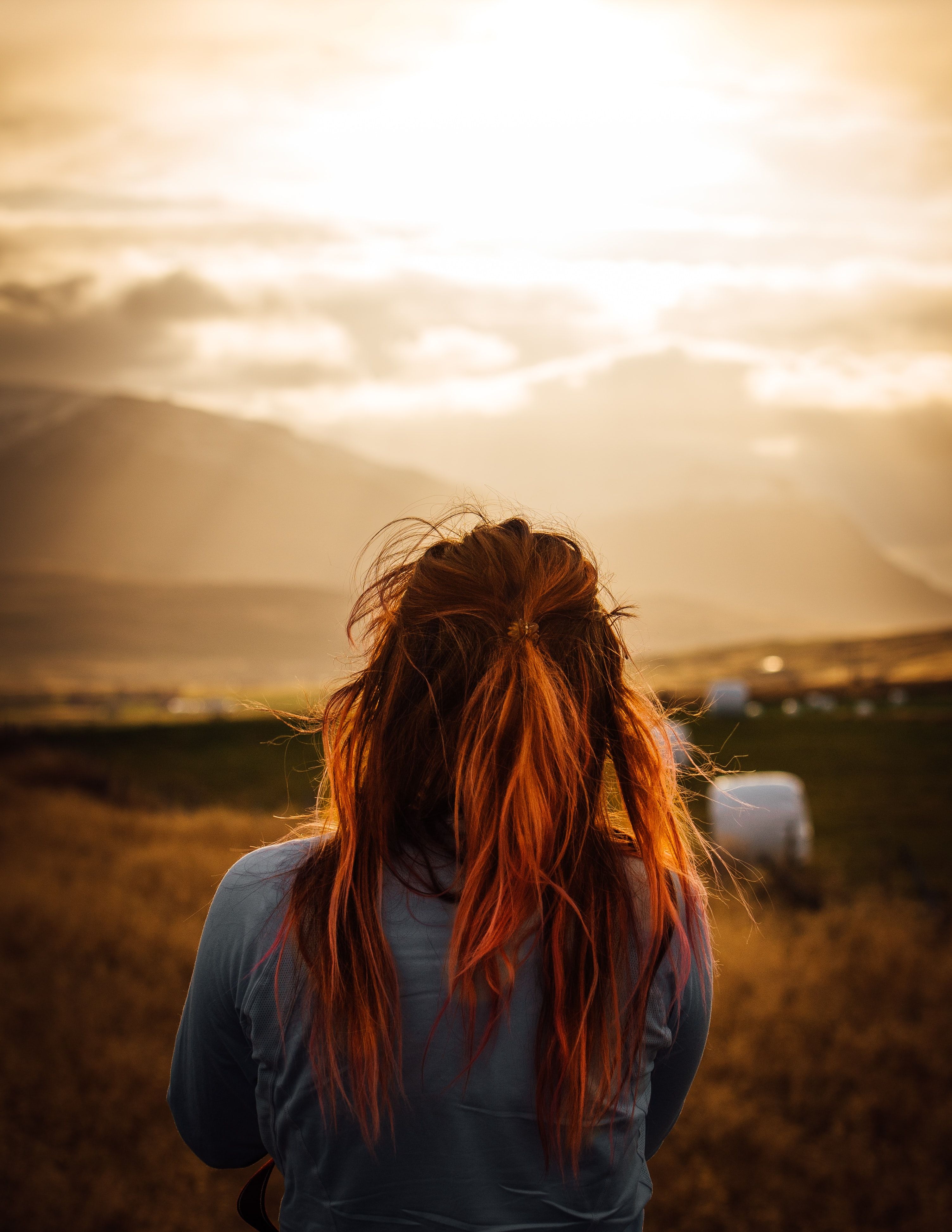 back view of woman facing grass fields photo