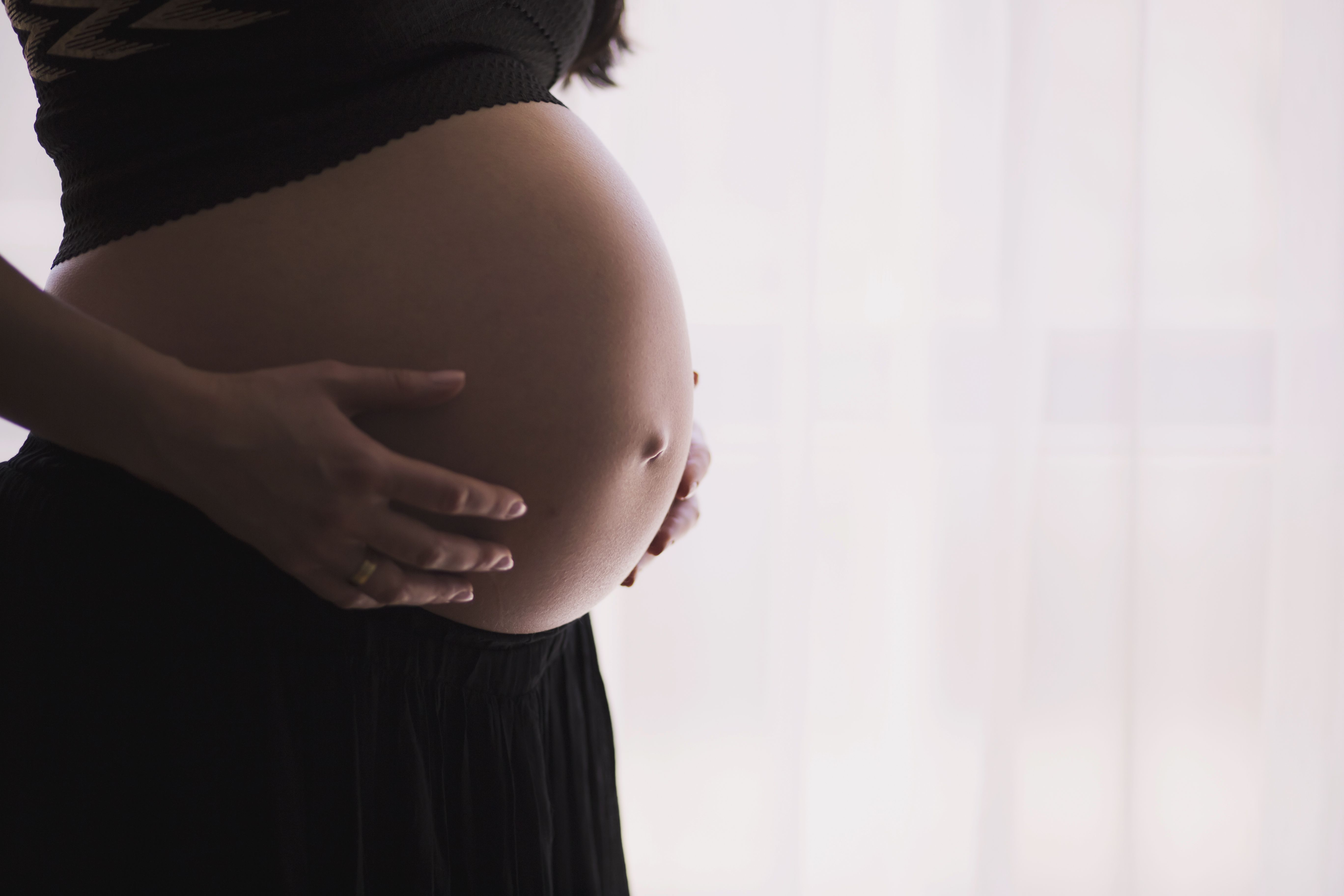 Pregnant Woman Holding Tummy · Free