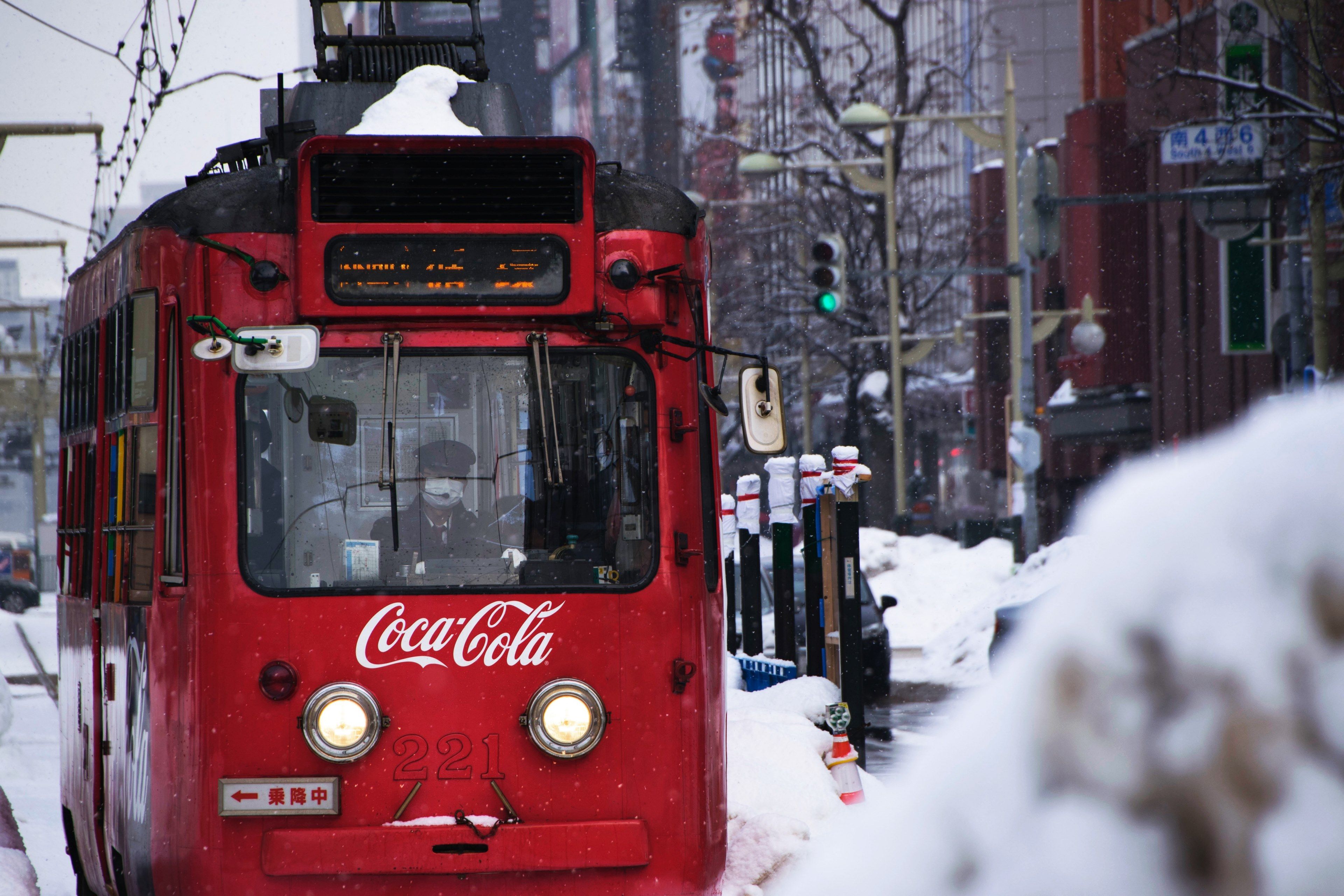 Wallpaper / a trolleybus in sapporo japan with coca cola branding on the front, coca cola trolleybus in japan 4k wallpaper