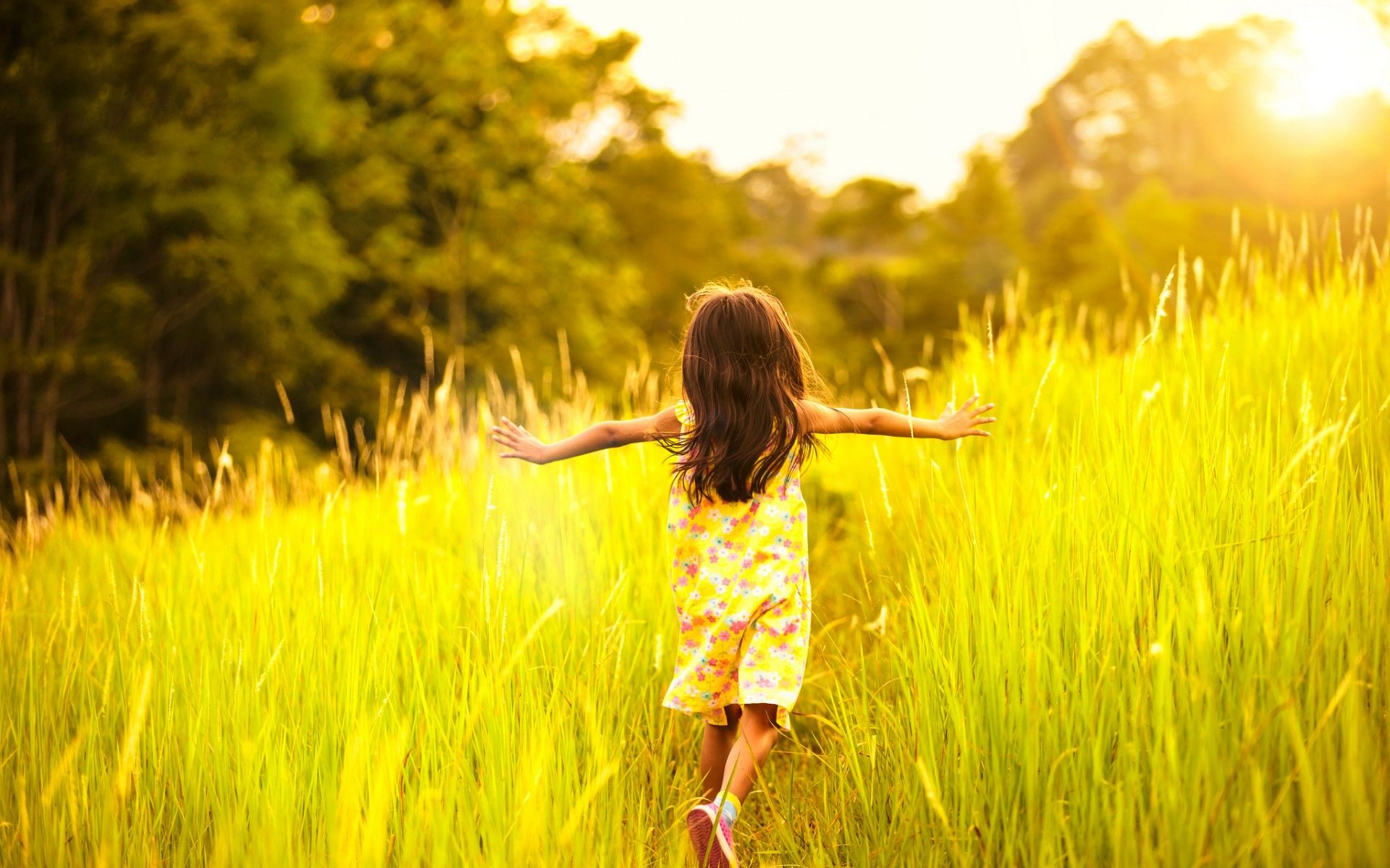 Little Girl Running On Meadow With Sunset wallpaper
