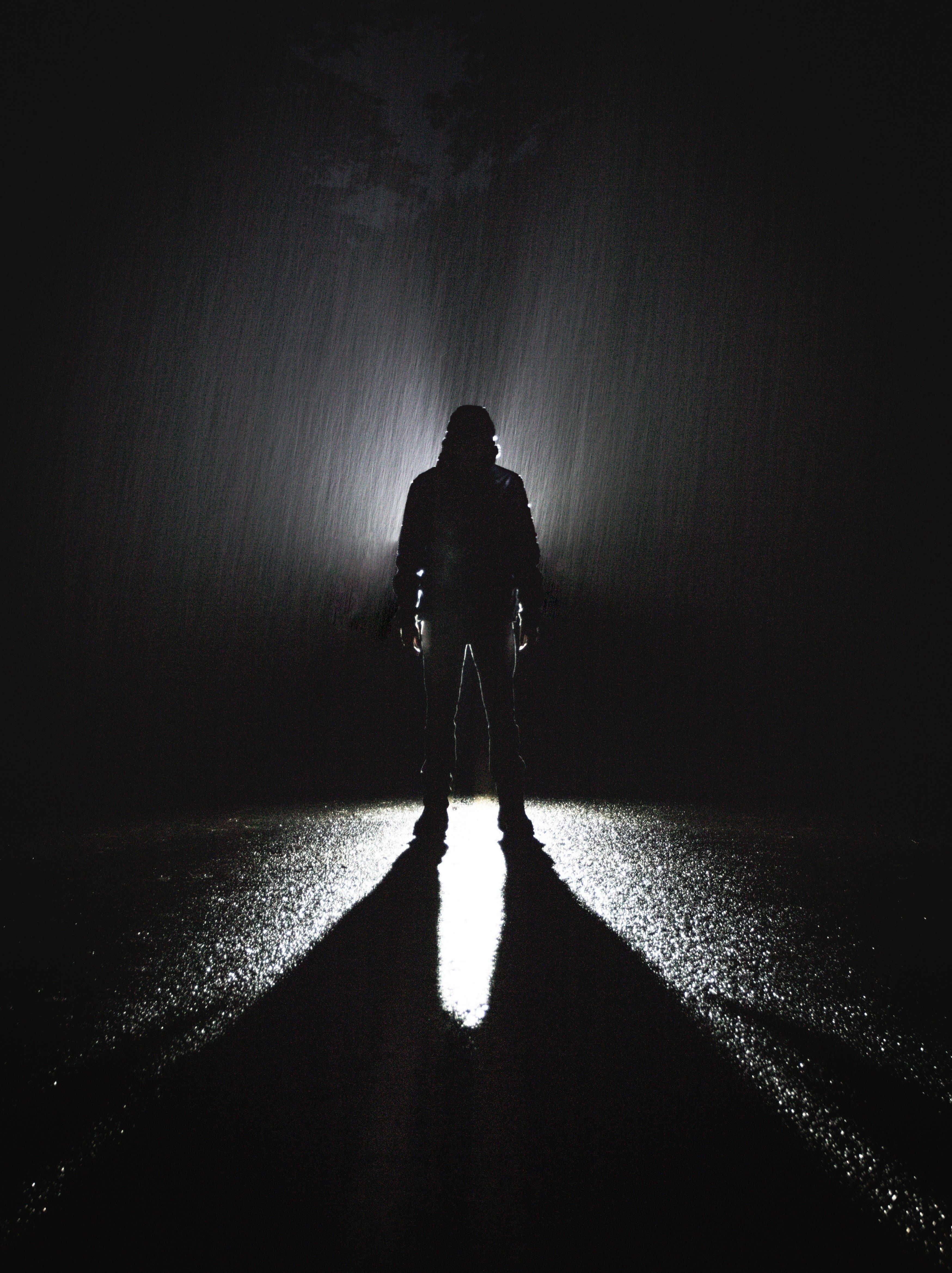 Wallpaper / the shadow of a man walking down a street