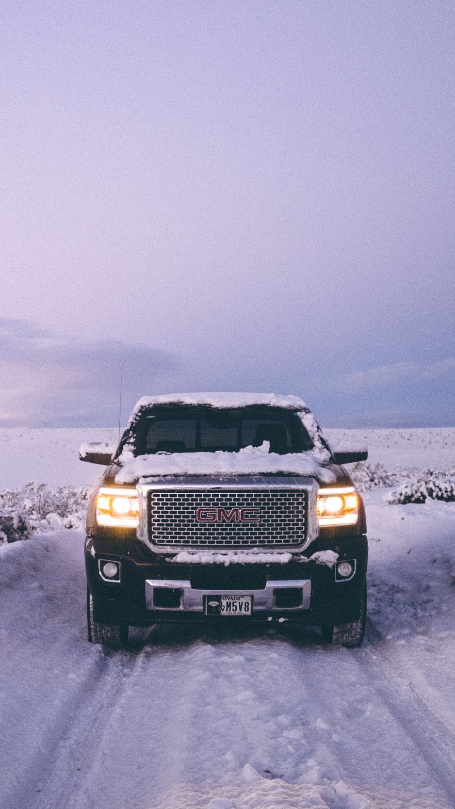 Download Wallpaper 938x1668 Gmc Sierra, Gmc, Pickup, Suv, Black, Front View, Snow, Winter, Offroad Iphone 8 7 6s 6 For Parallax HD Background