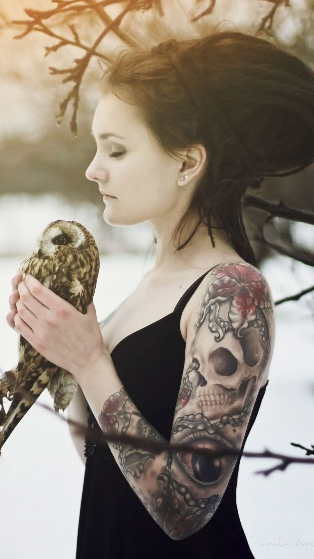 Tattooed rasta girl holding an owl Mobile Wallpaper. Arm tattoos