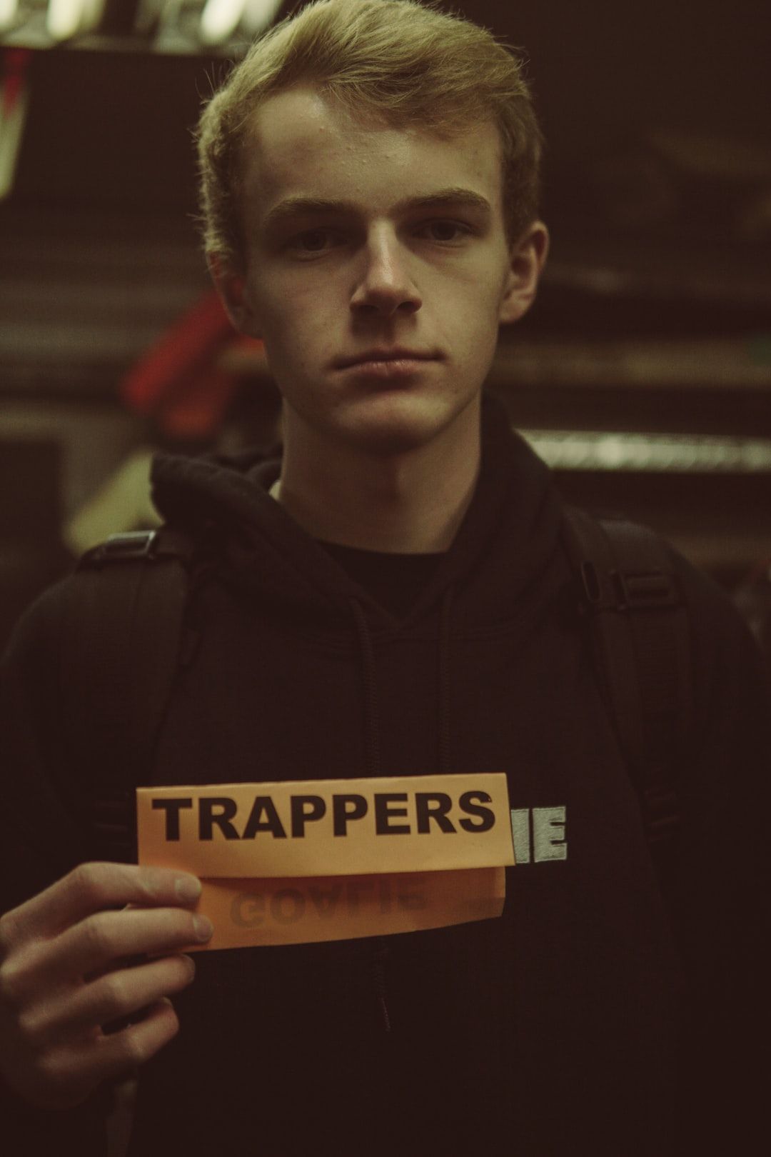 man standing and holding Trappers sign photo