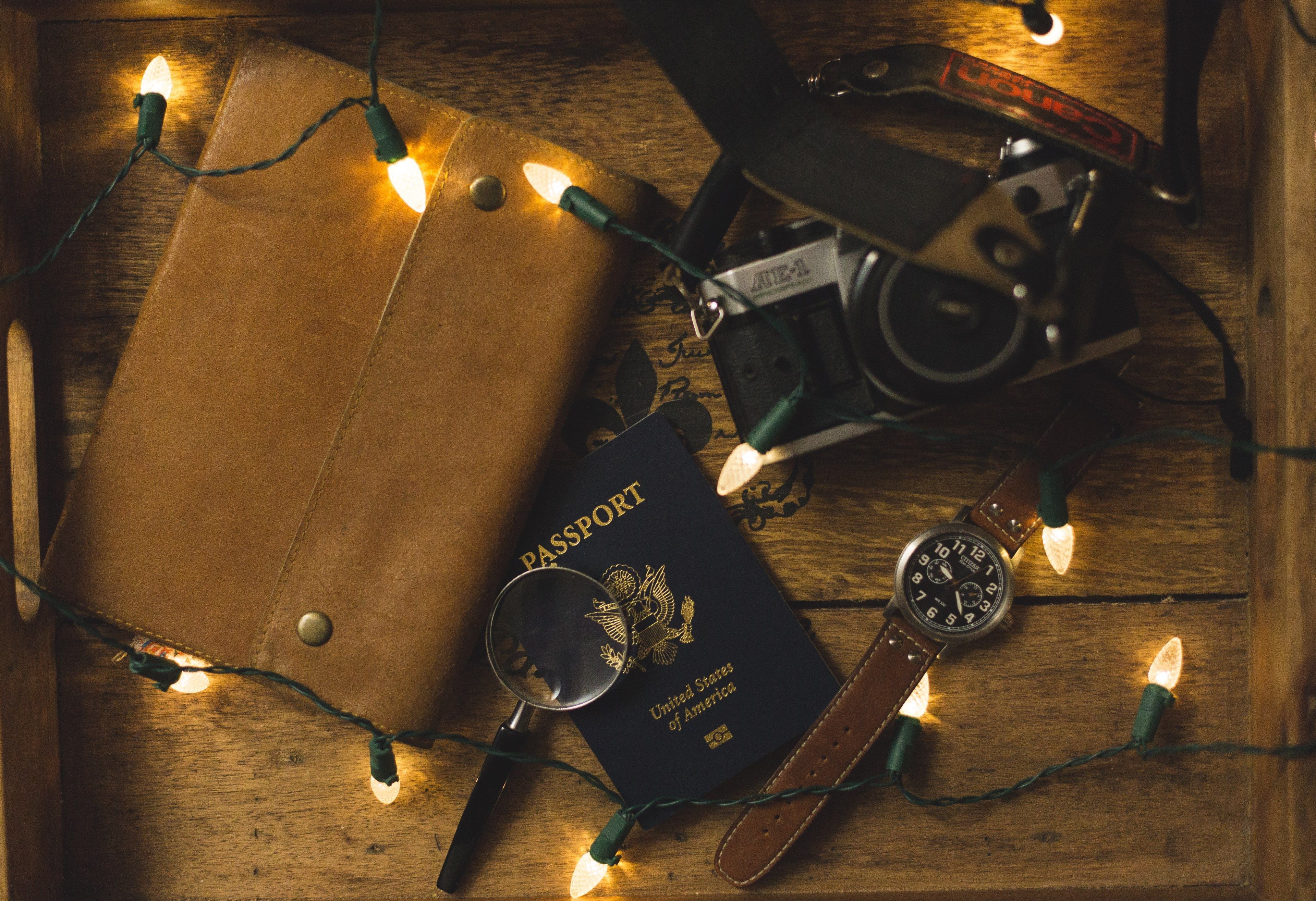 Wallpaper / flatlay passport watch and magnifying glass