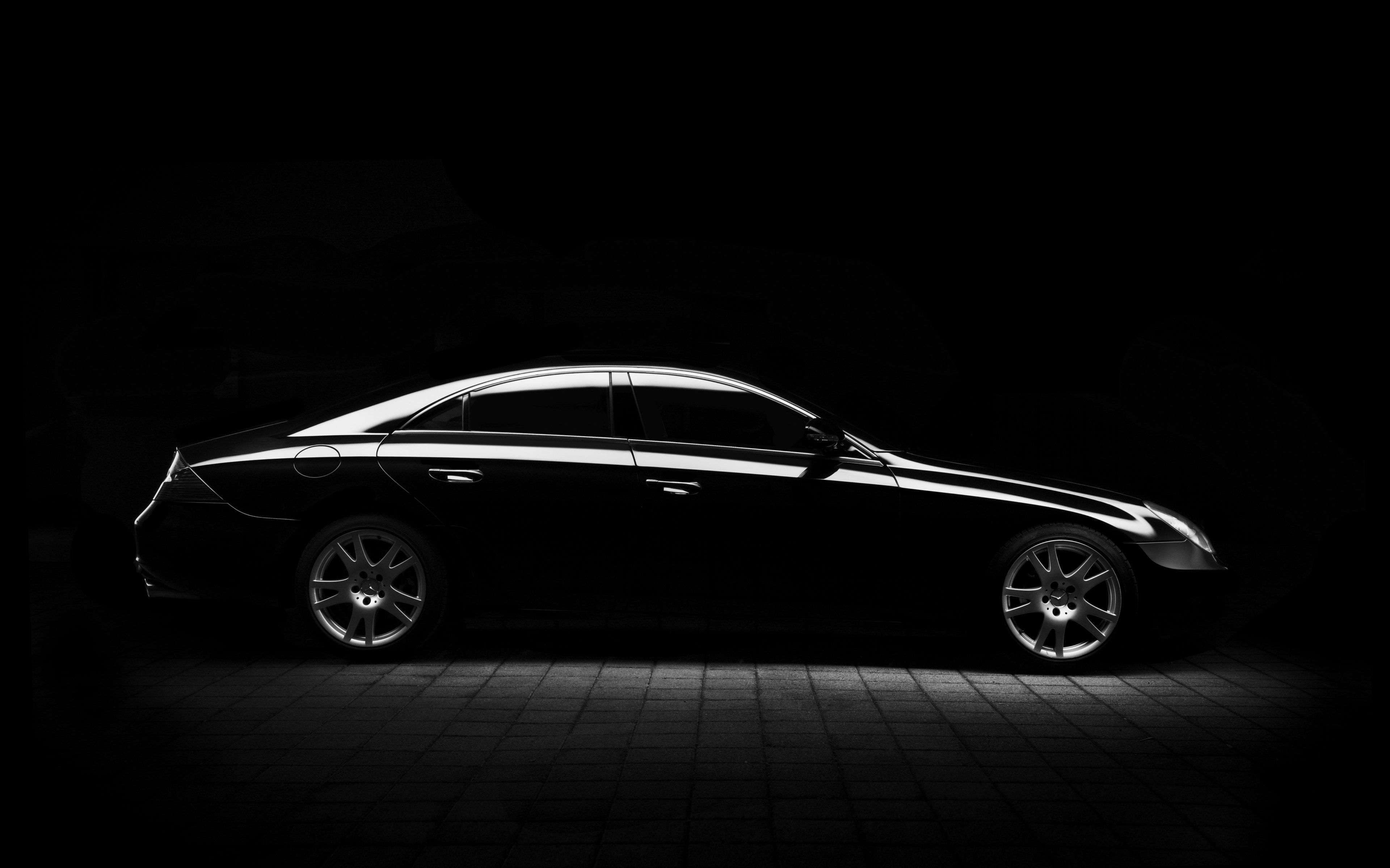 Wallpaper / black and white shot of black mercedes benz saloon car on pavement at night, mercedes minimal silhouette 4k wallpaper