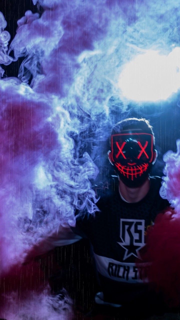 Man wearing a mask through colored smoke HD Wallpaper 720x1280