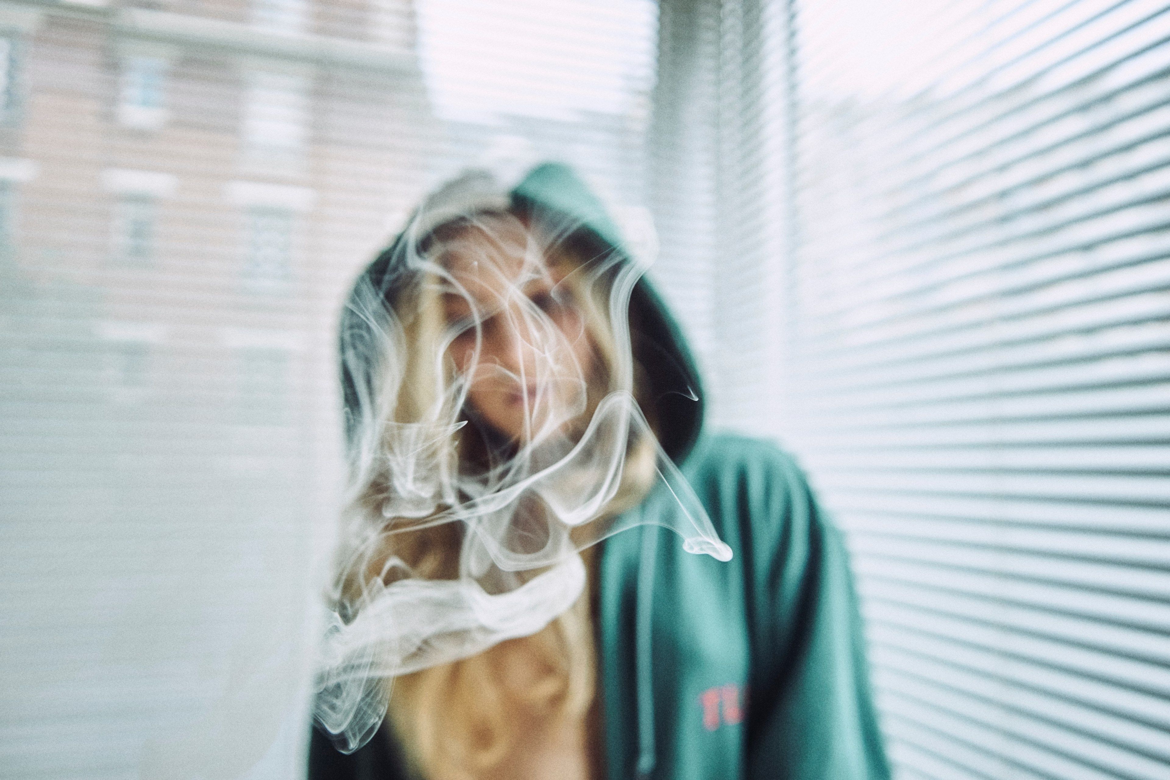Wallpaper / a blonde woman wearing a hoodie standing