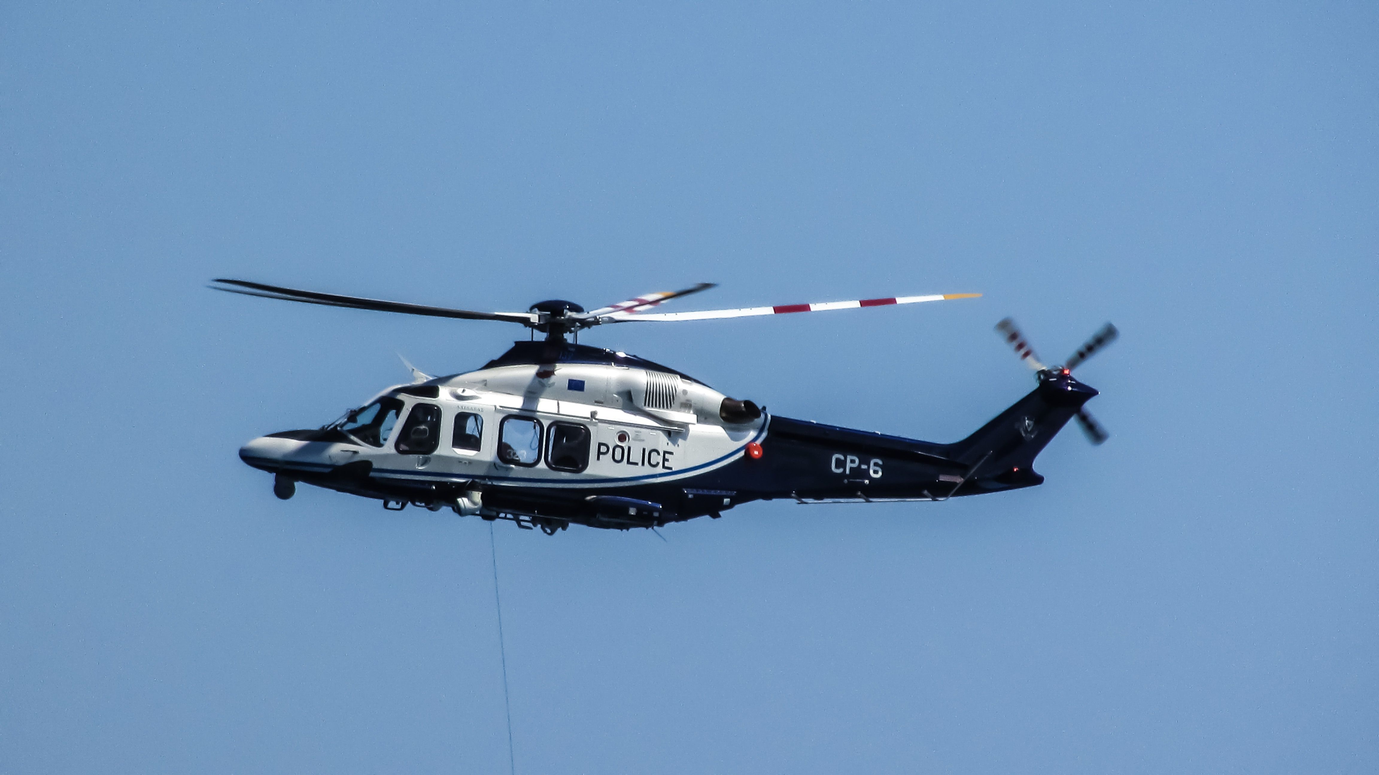 white and black police helicopter free image