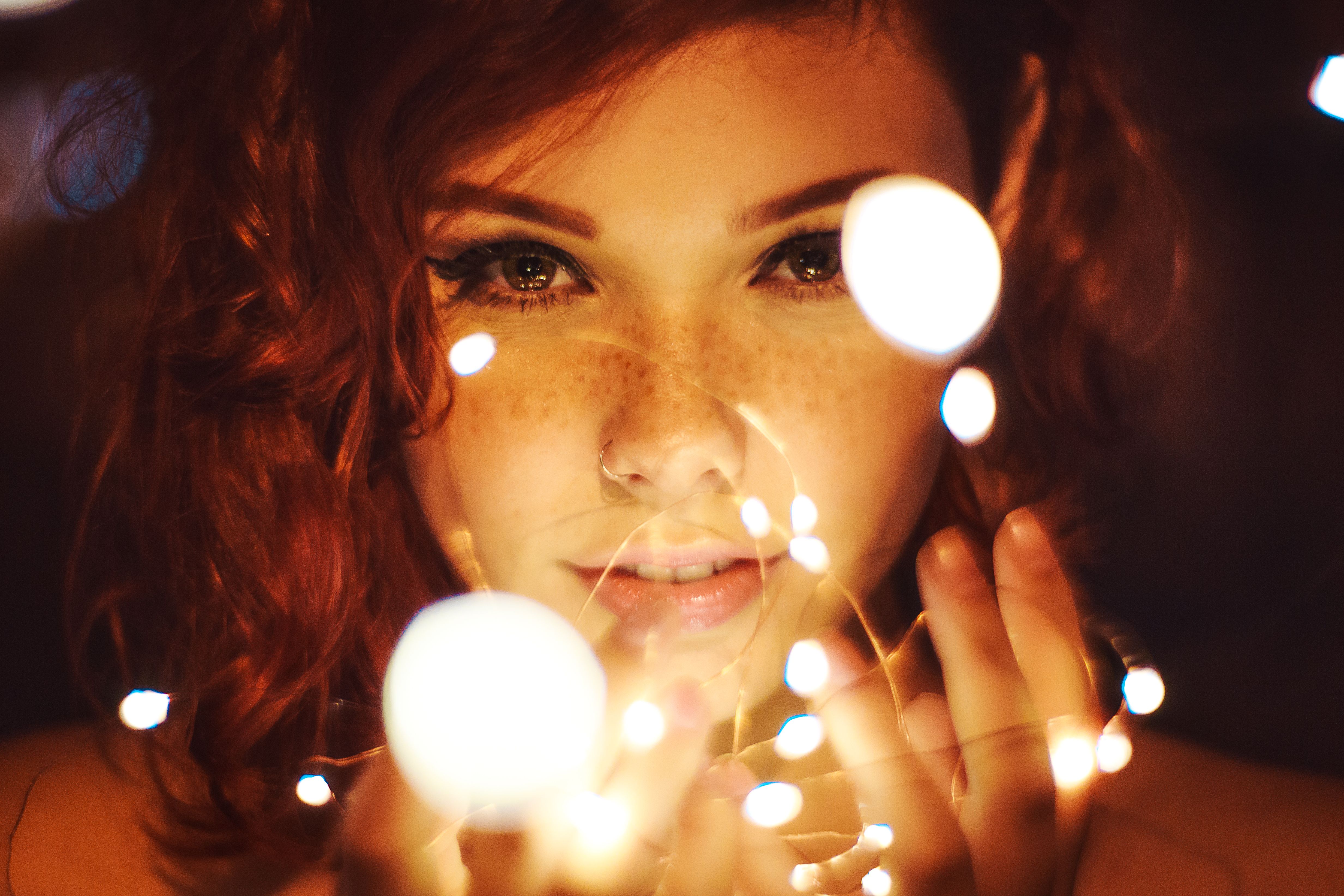 Photography of a Woman Holding Lights · Free