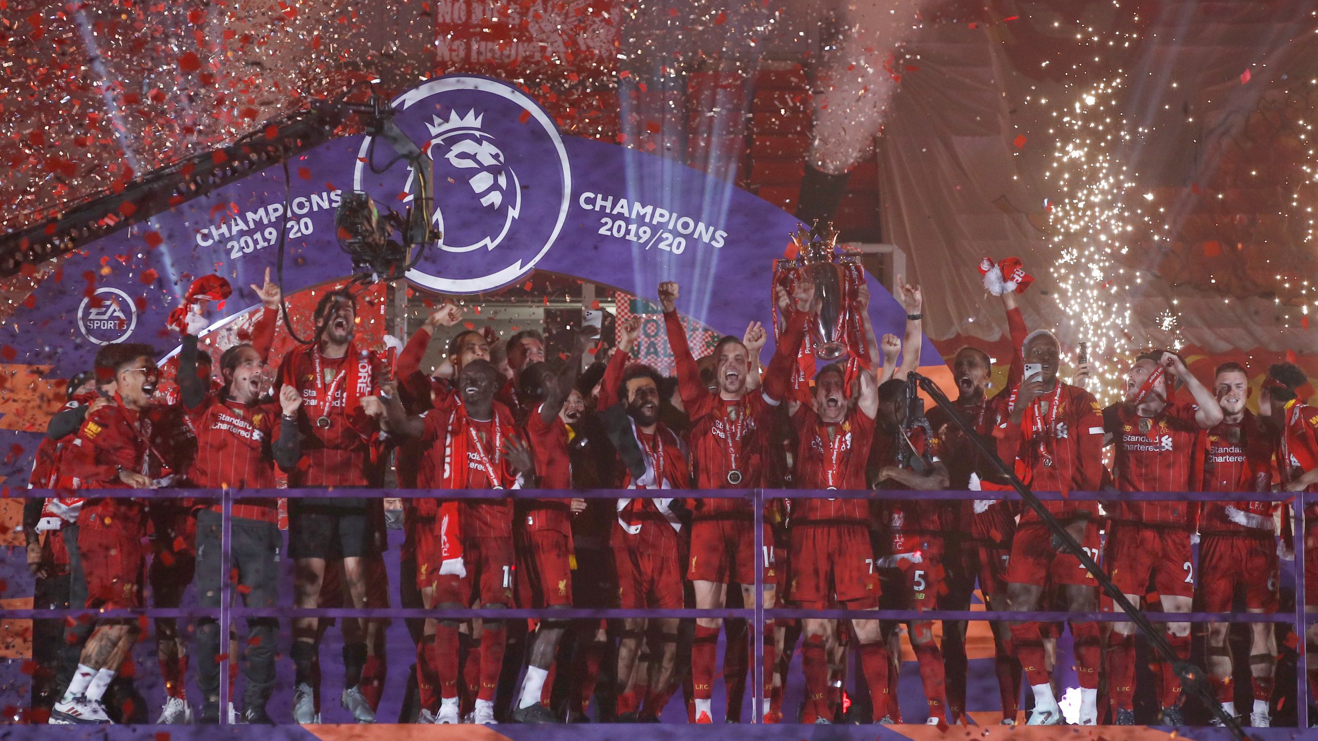 Liverpool players receive Premier League trophy on Kop