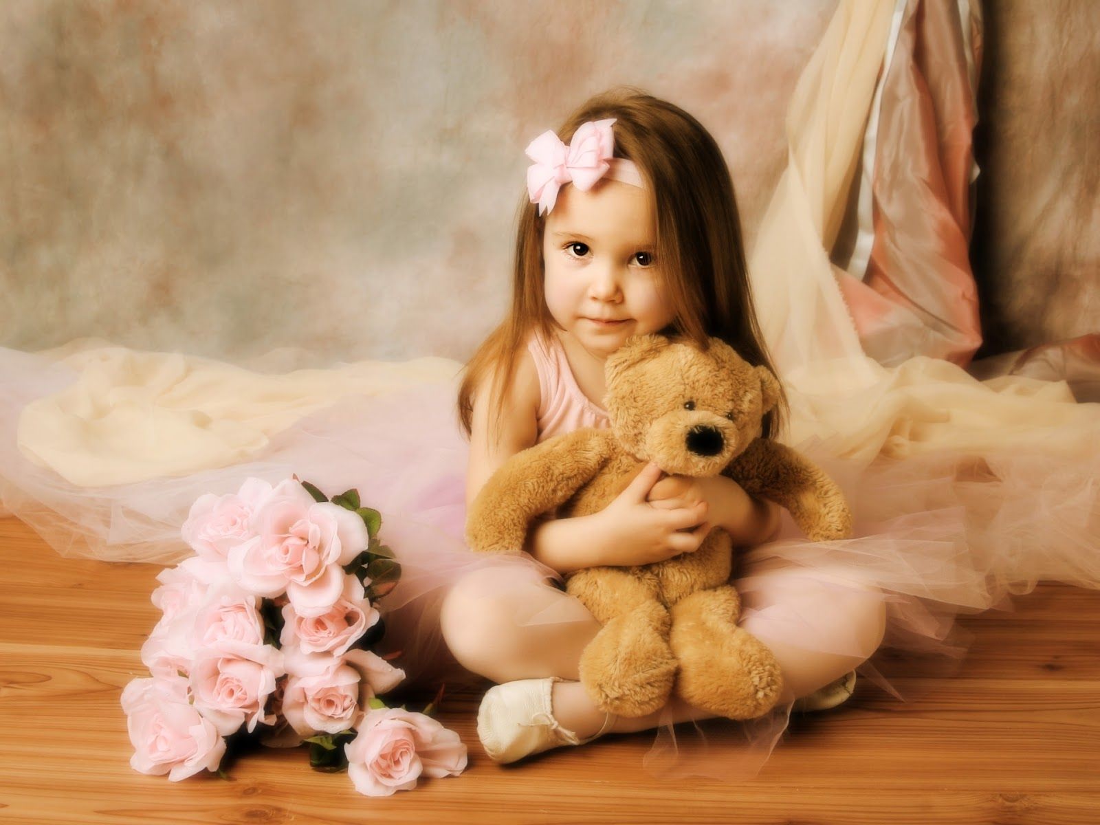 Little girl hugging a teddy bear.