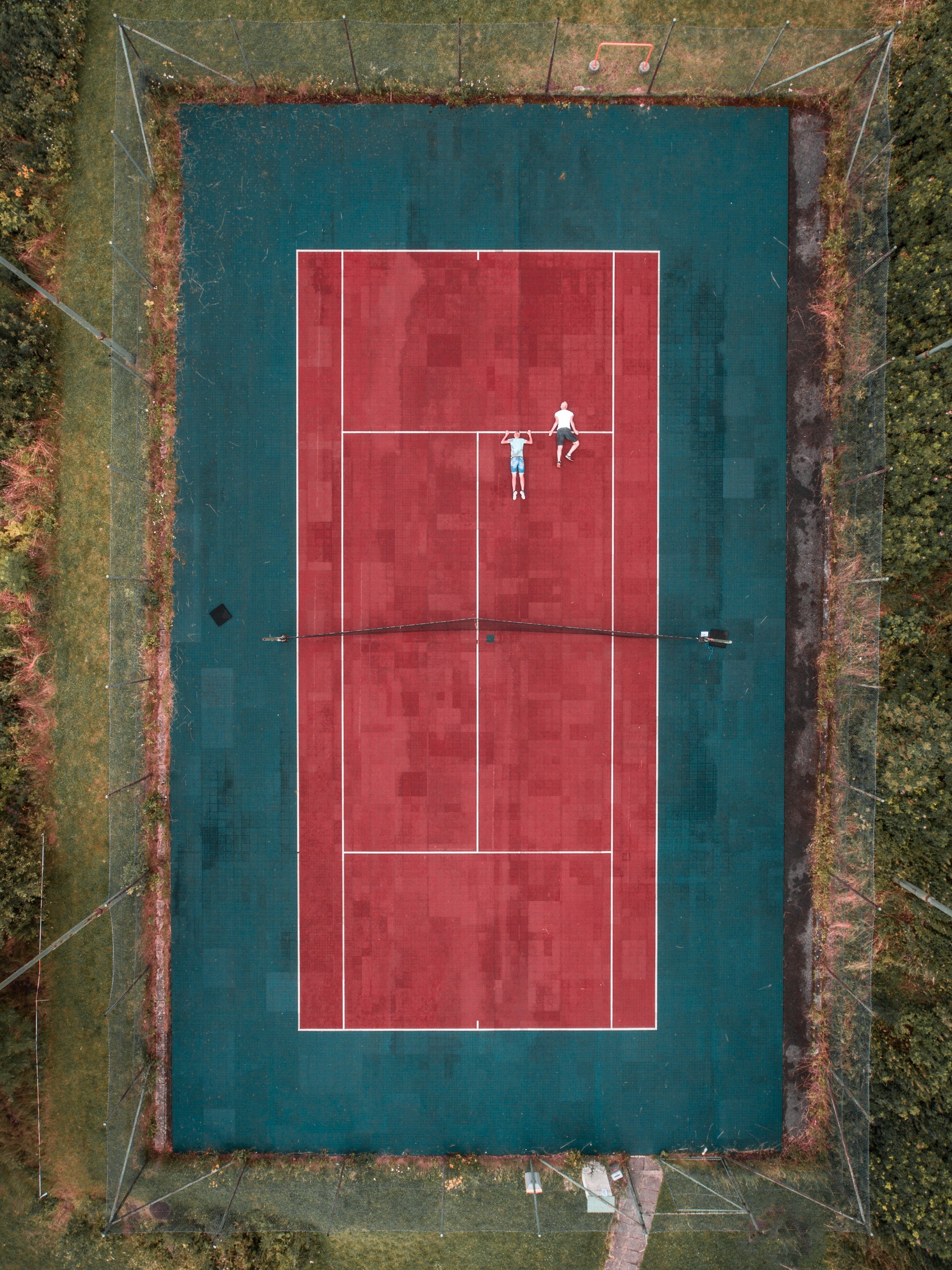 Wallpaper / a drone looking down at an outdoor tennis
