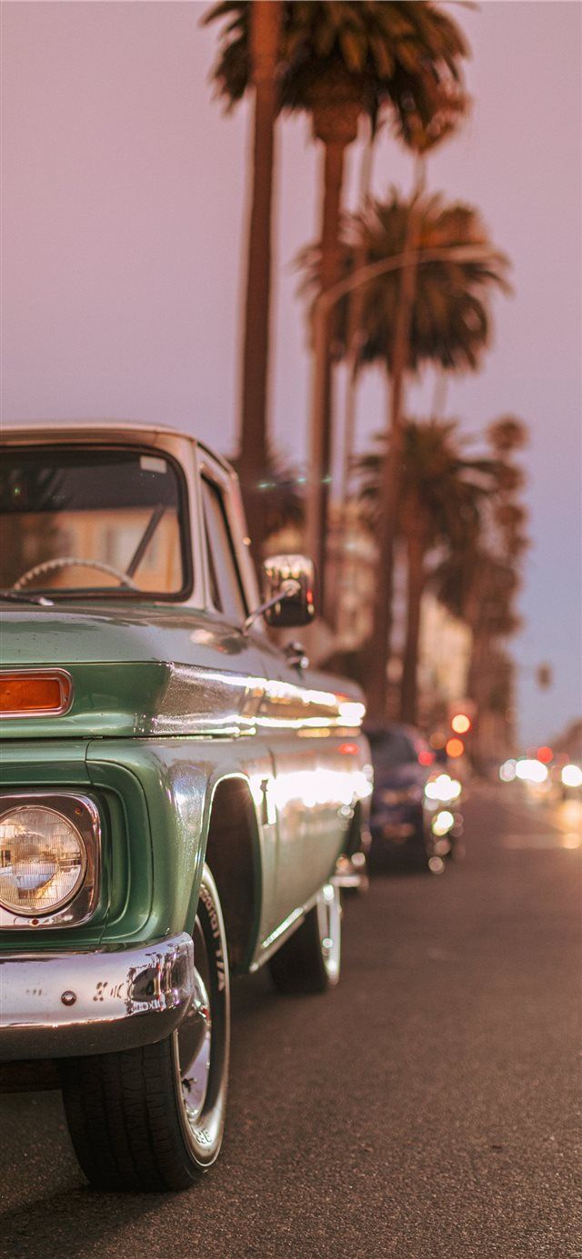 Vintage car parked on Ocean Blvd during sunset iPhone X Wallpaper Free Download