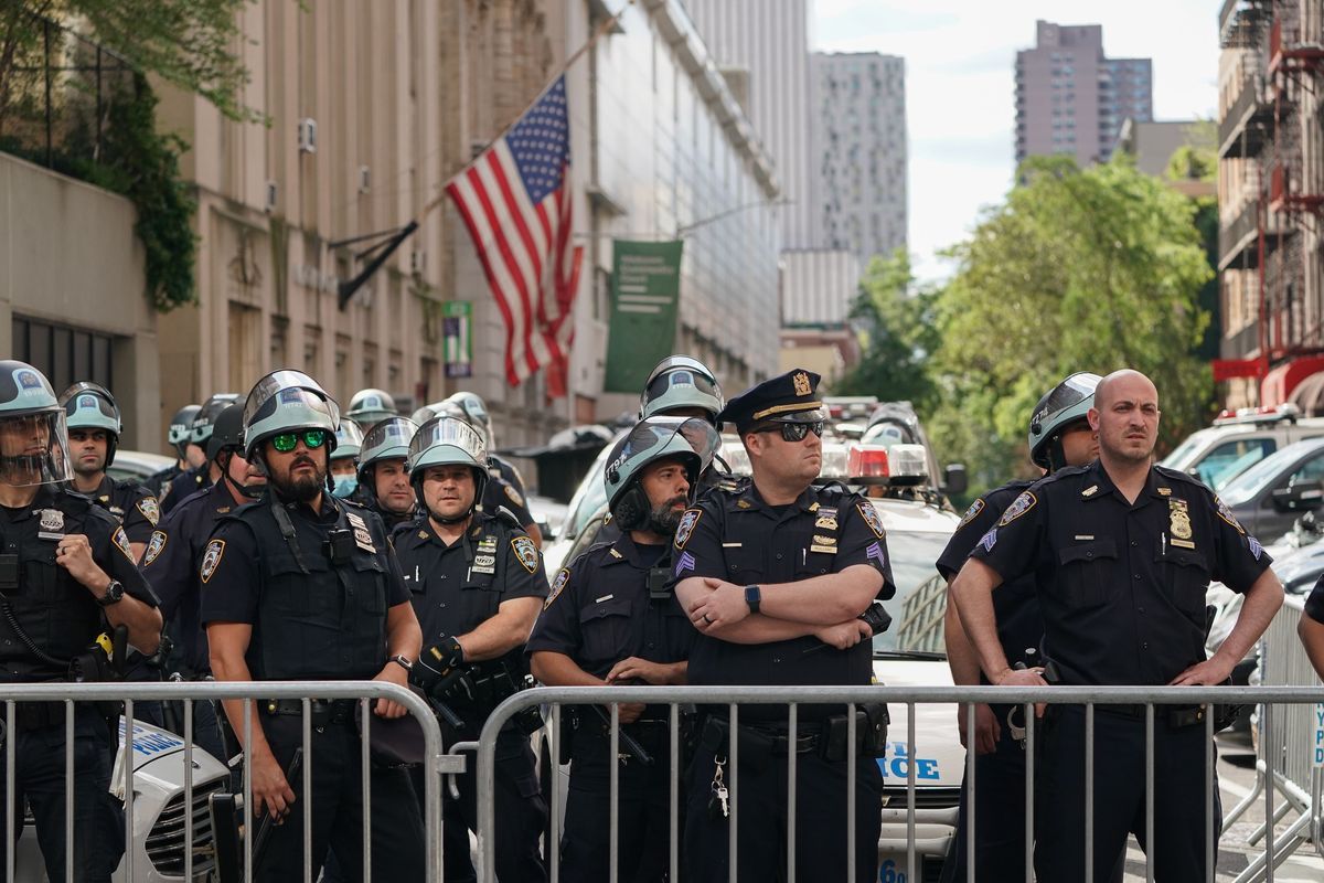 Police officers have been seen without masks at protests. Here's why that matters