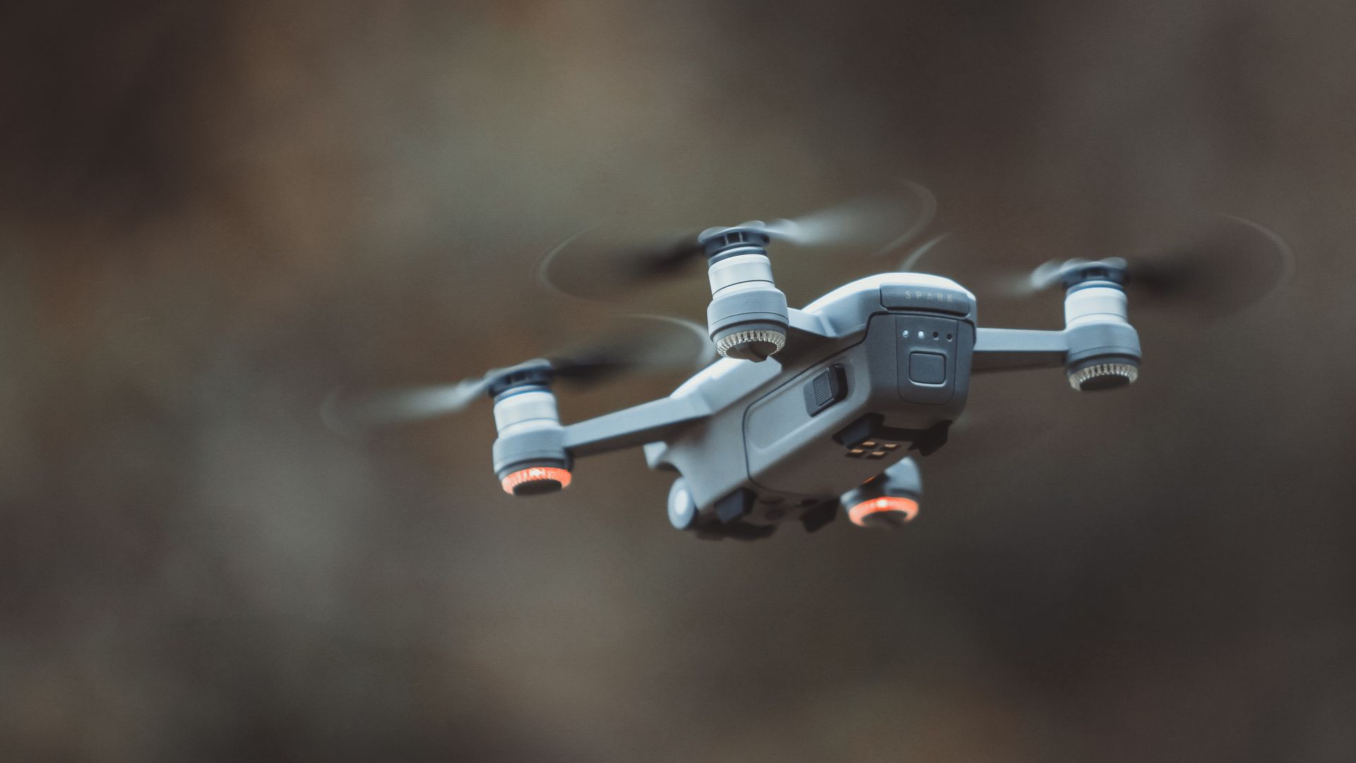 Grey Quadcopter Drone Blurred Background Wallpaper