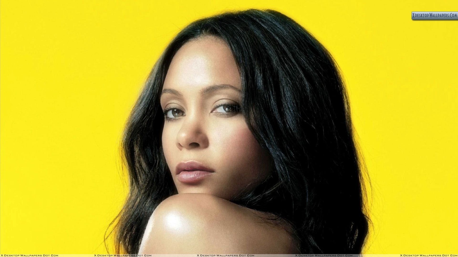 Thandie Newton Side Face Closeup And Yellow Background Wallpaper