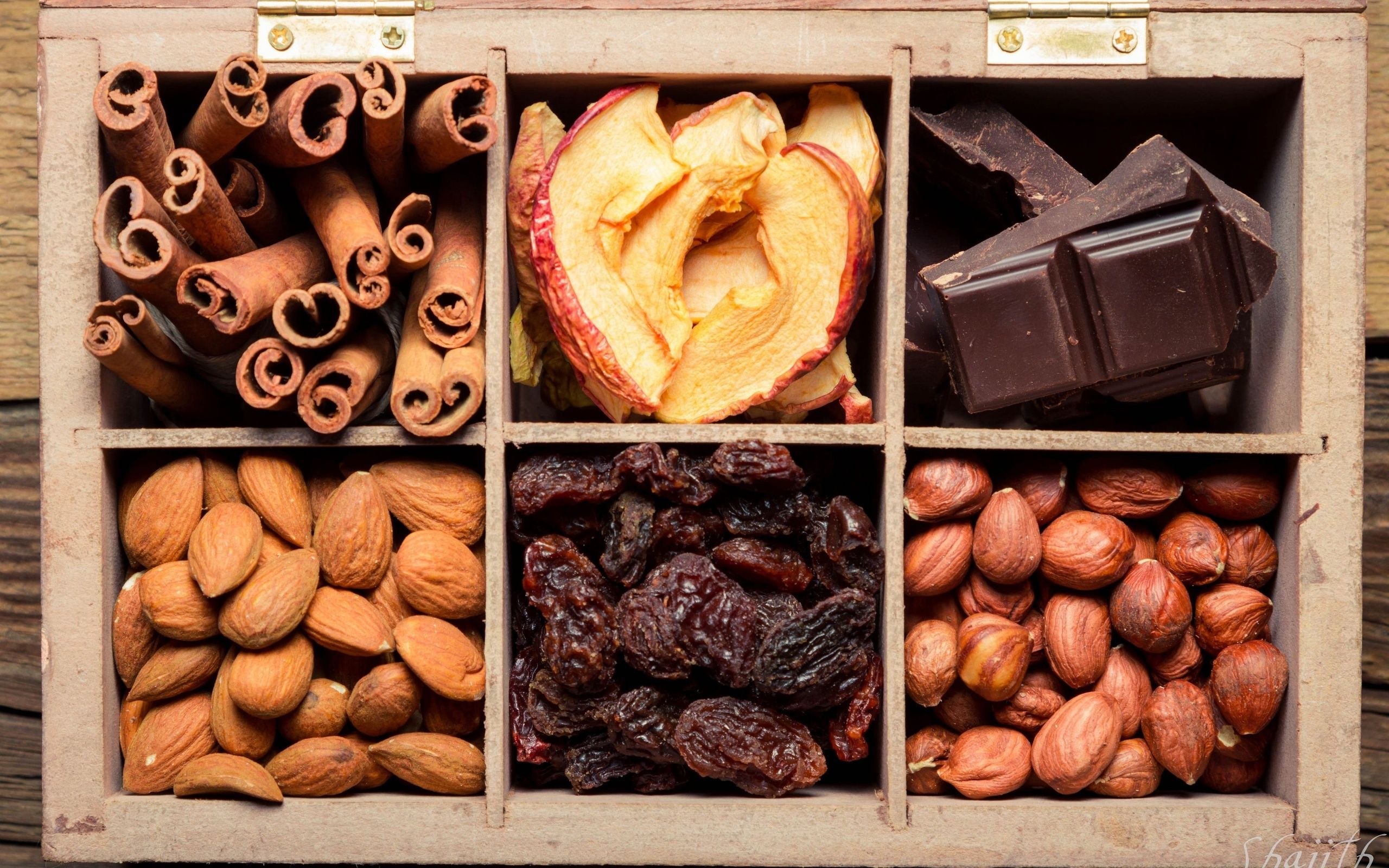 Nuts dried fruit chocolate raisins apples cinnamon almonds hazelnuts box wallpaperx1600