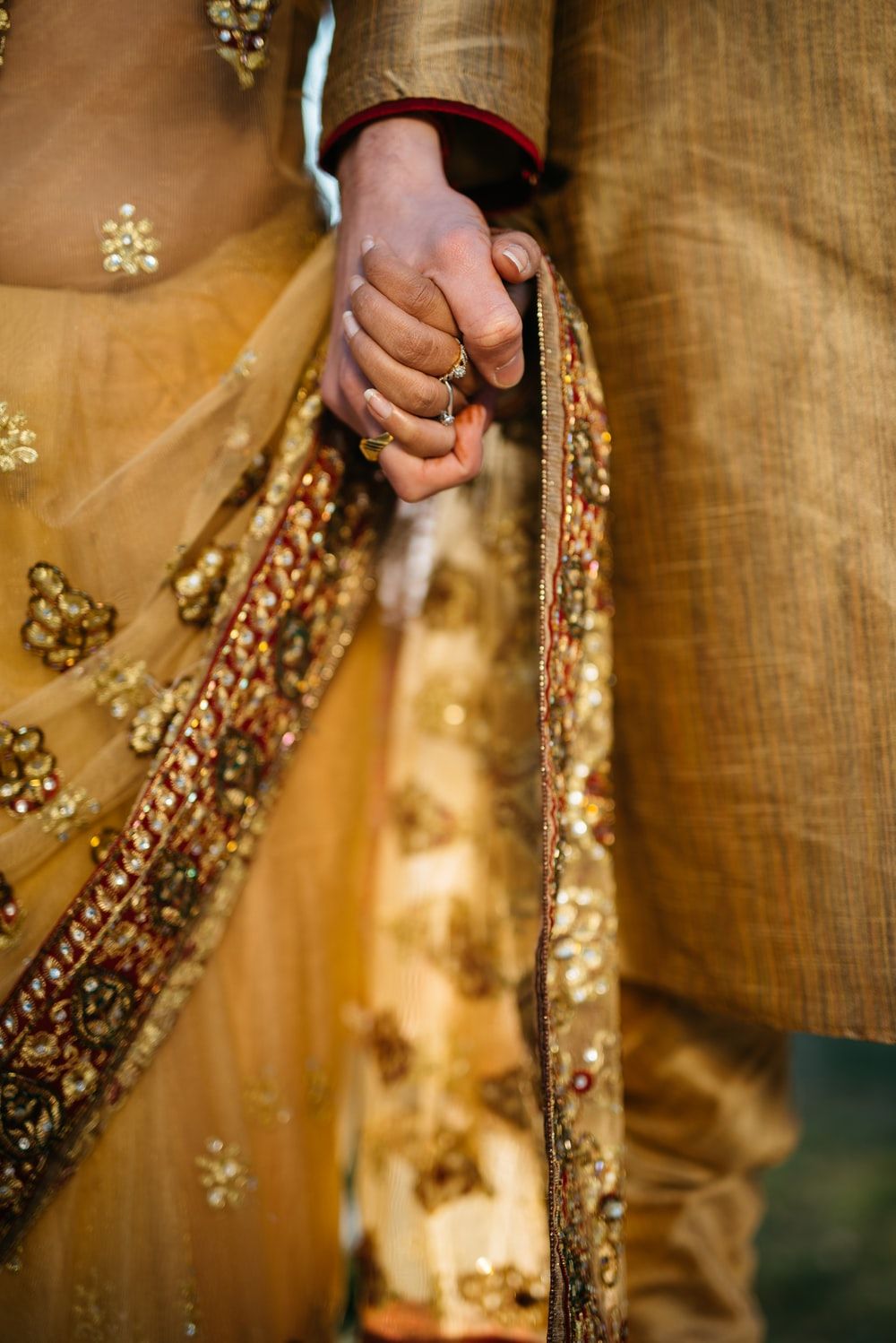 selective focus of two person holding hands photo