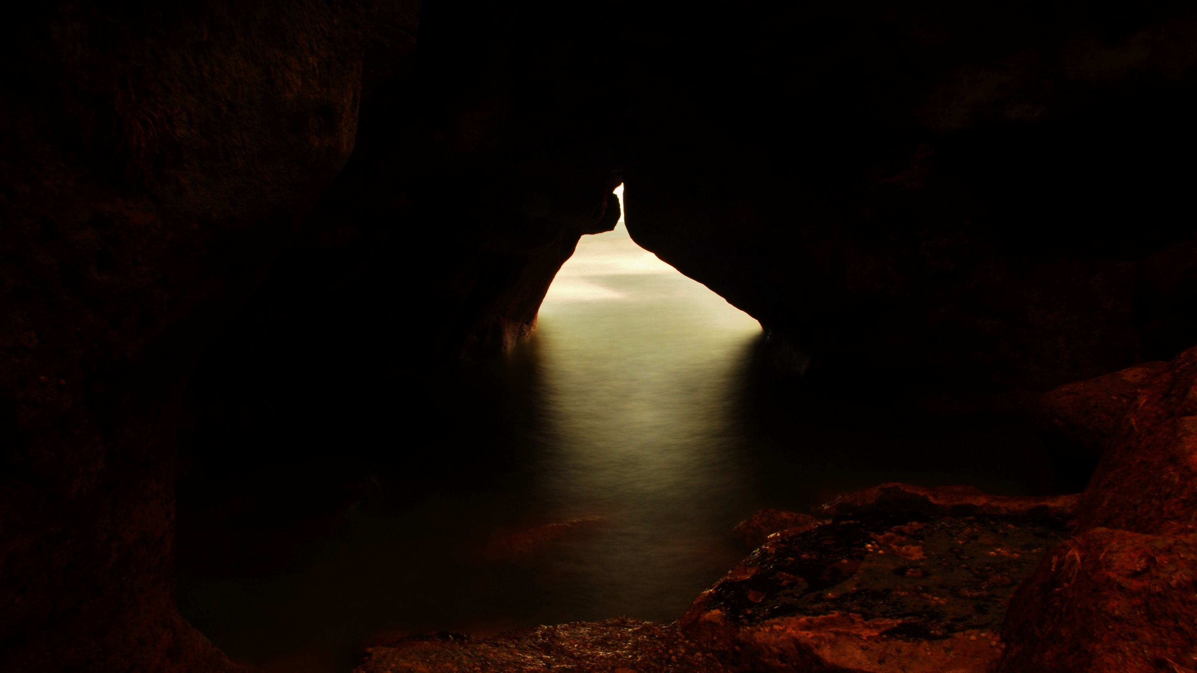 Download wallpaper 3840x2160 cave, gorge, water, light, dark 4k uhd 16:9 HD background