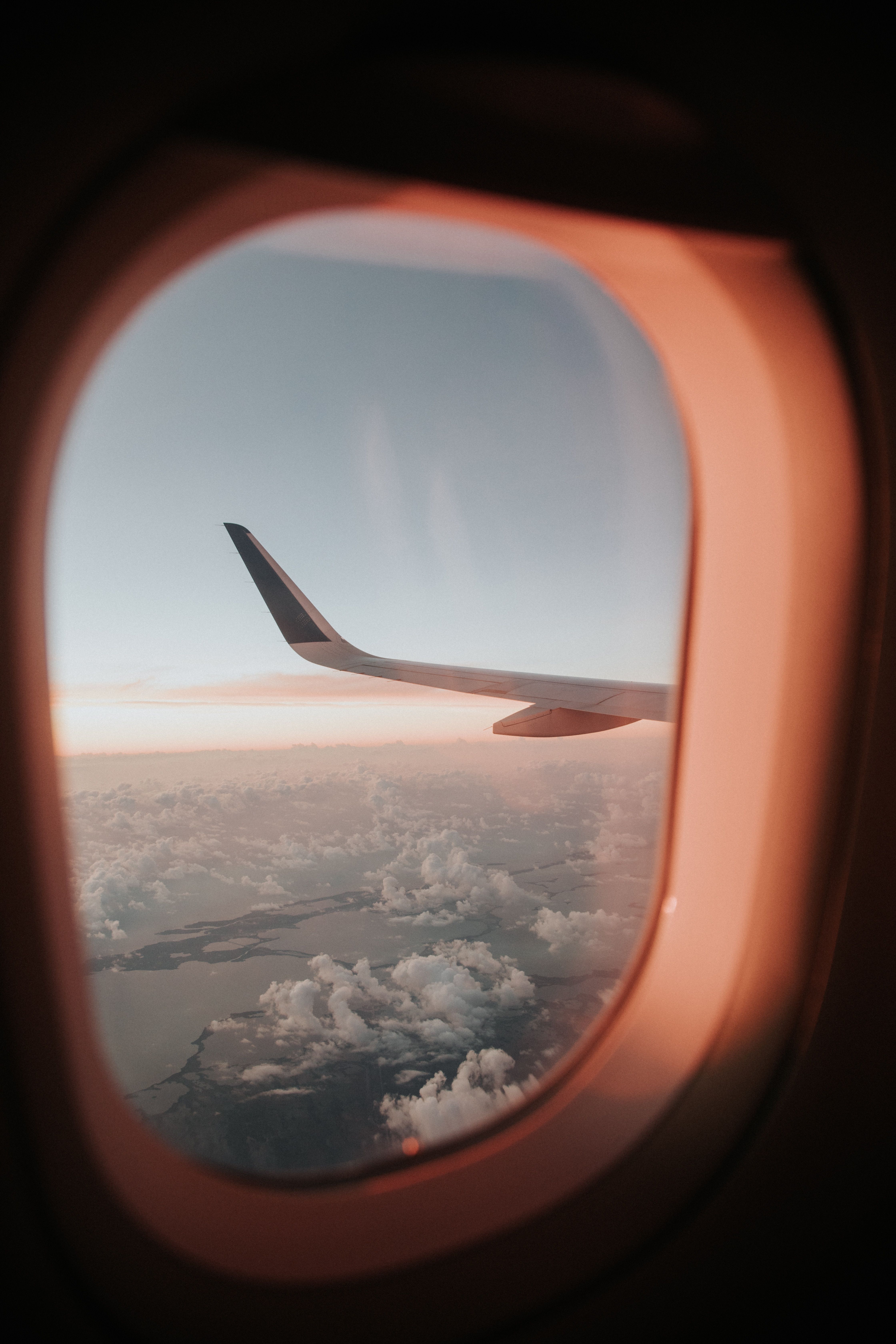 Download wallpaper 4480x6720 porthole, airplane window, aircraft wing, flight, sky HD background