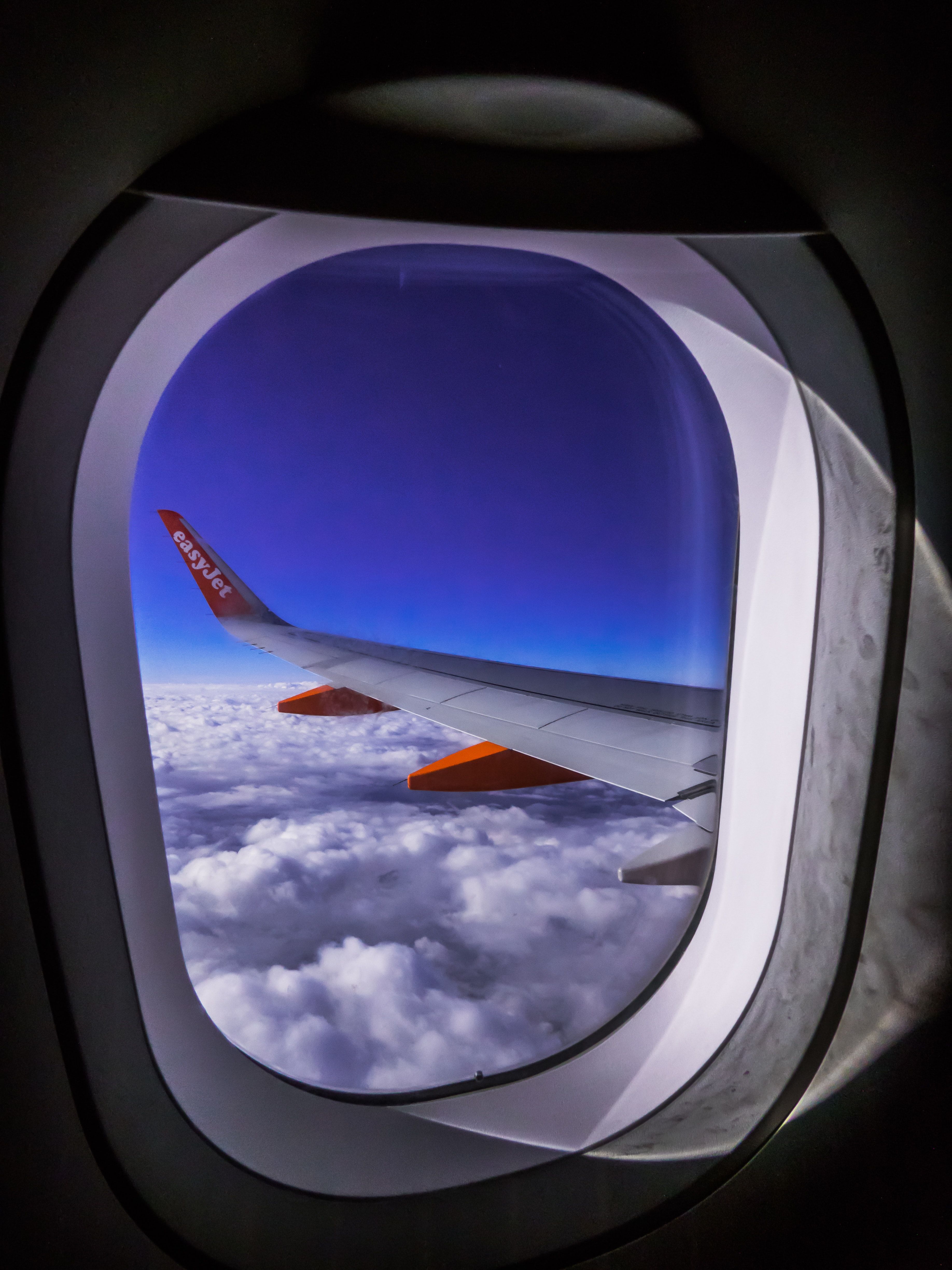 Airplane Window Overlooking Clouds · Free