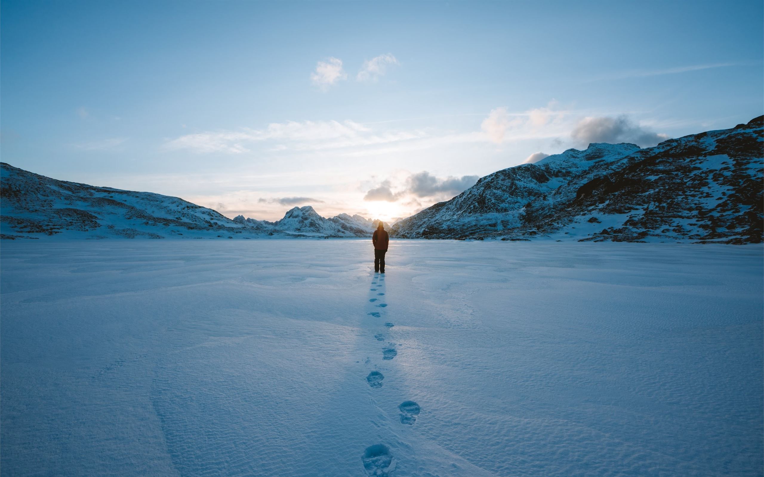 person walking on snow field leaving foot prints MacBook Air Wallpaper Download
