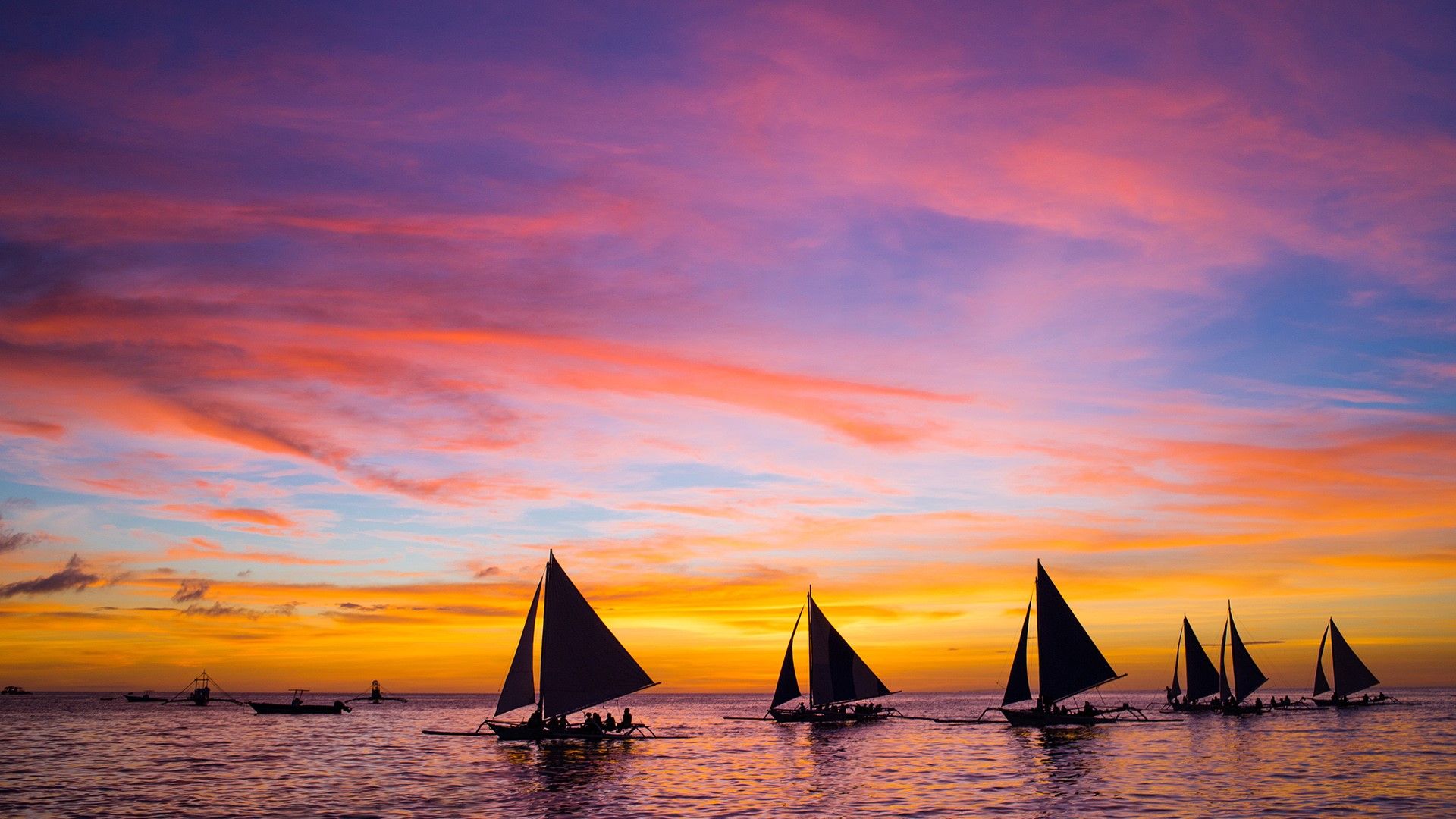 Sailing boats in the sea at sunset, Boracay, Philippines. Windows 10 Spotlight Image