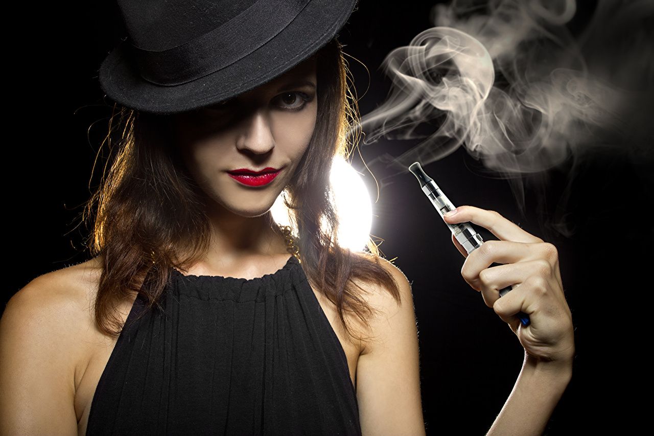 Image Brown haired Electronic cigarette vaping Hat young woman Hands