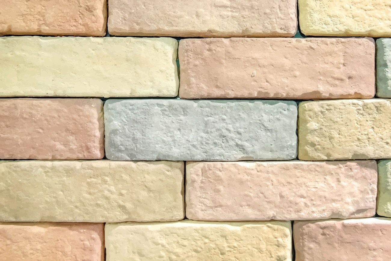 Pastel brick wall textured wallpaper vector