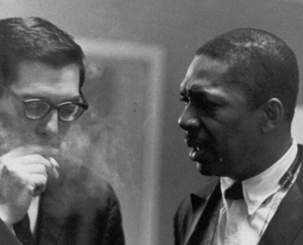 Rare photo of John Coltrane talking to Bill Evans