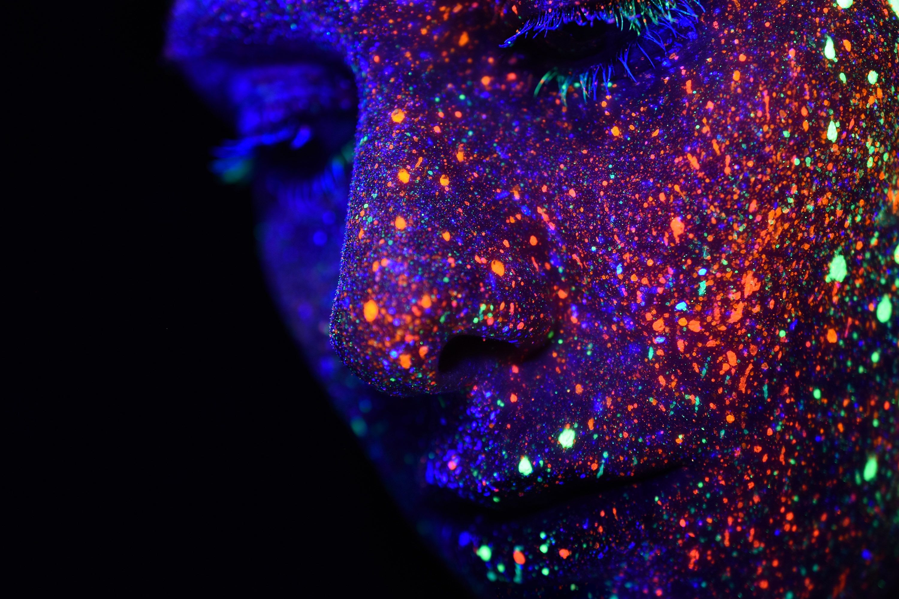 wallpaper. close up photography of person with uv reactive paint on face