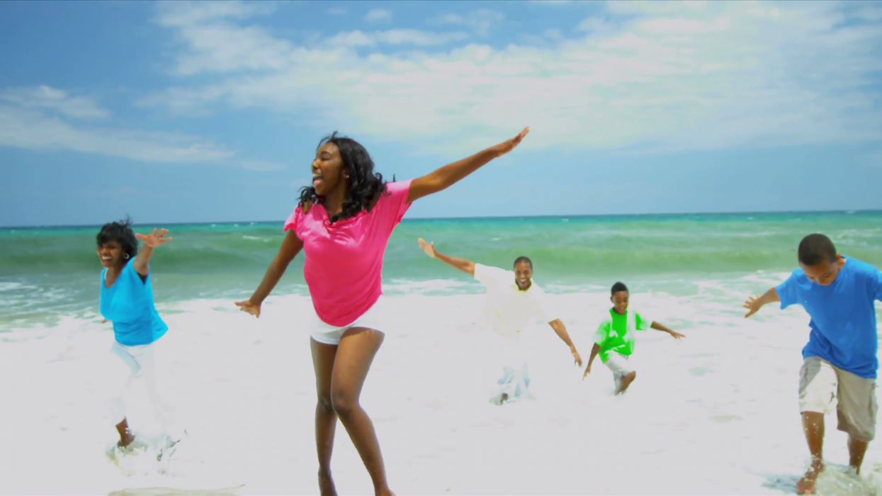 African american family spending summer holiday together on beach wallpaperx1080