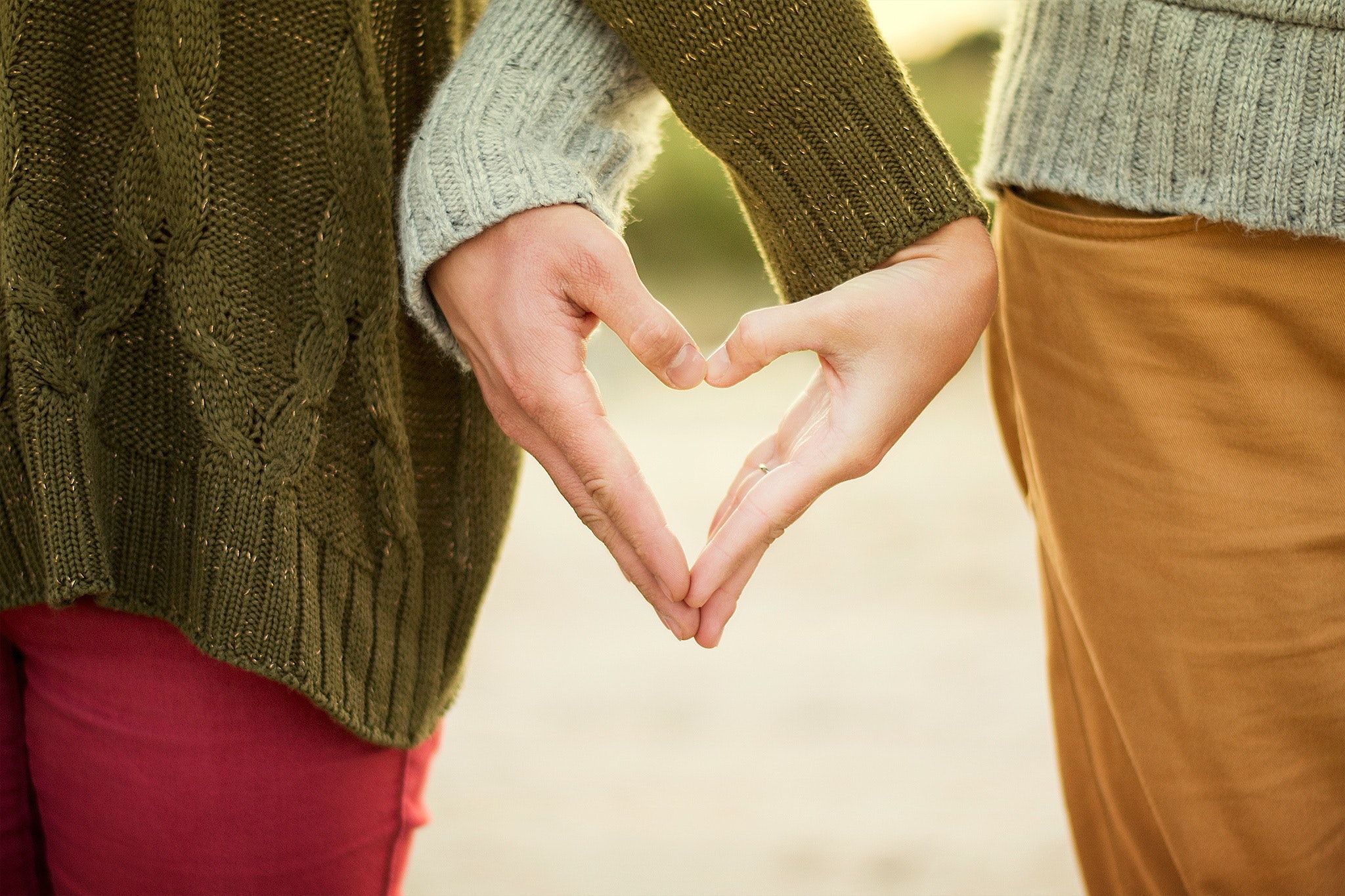 Selective Focus Photography Two Person Making Heart Hand Sign · Free